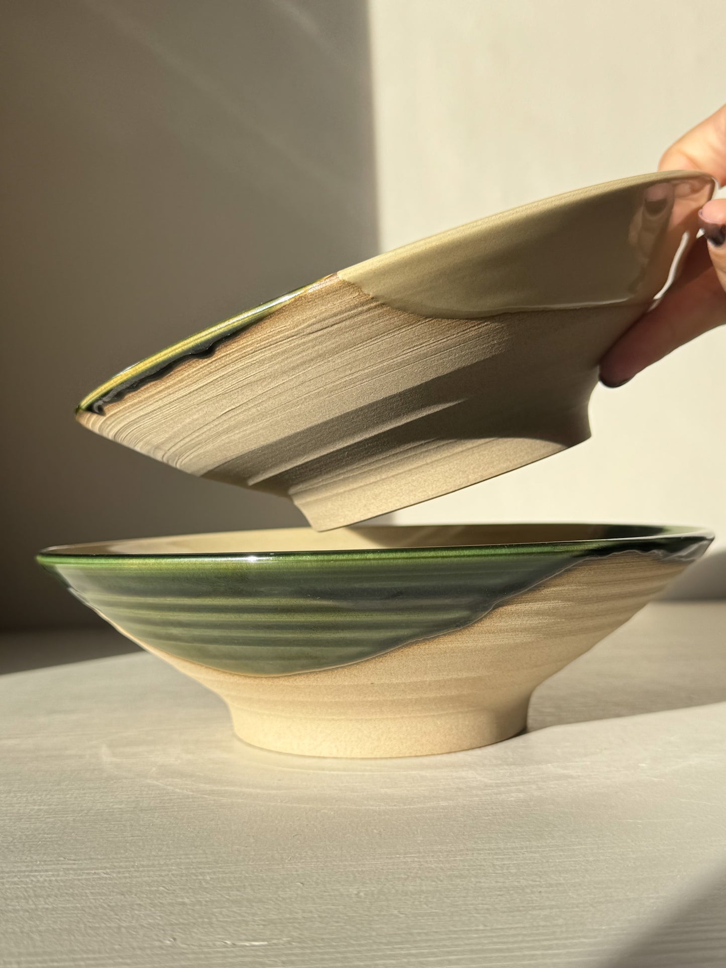 Handcrafted Salad/Pasta Plate – Mori with green glaze draping over the rim, revealing a unique raw stoneware base.