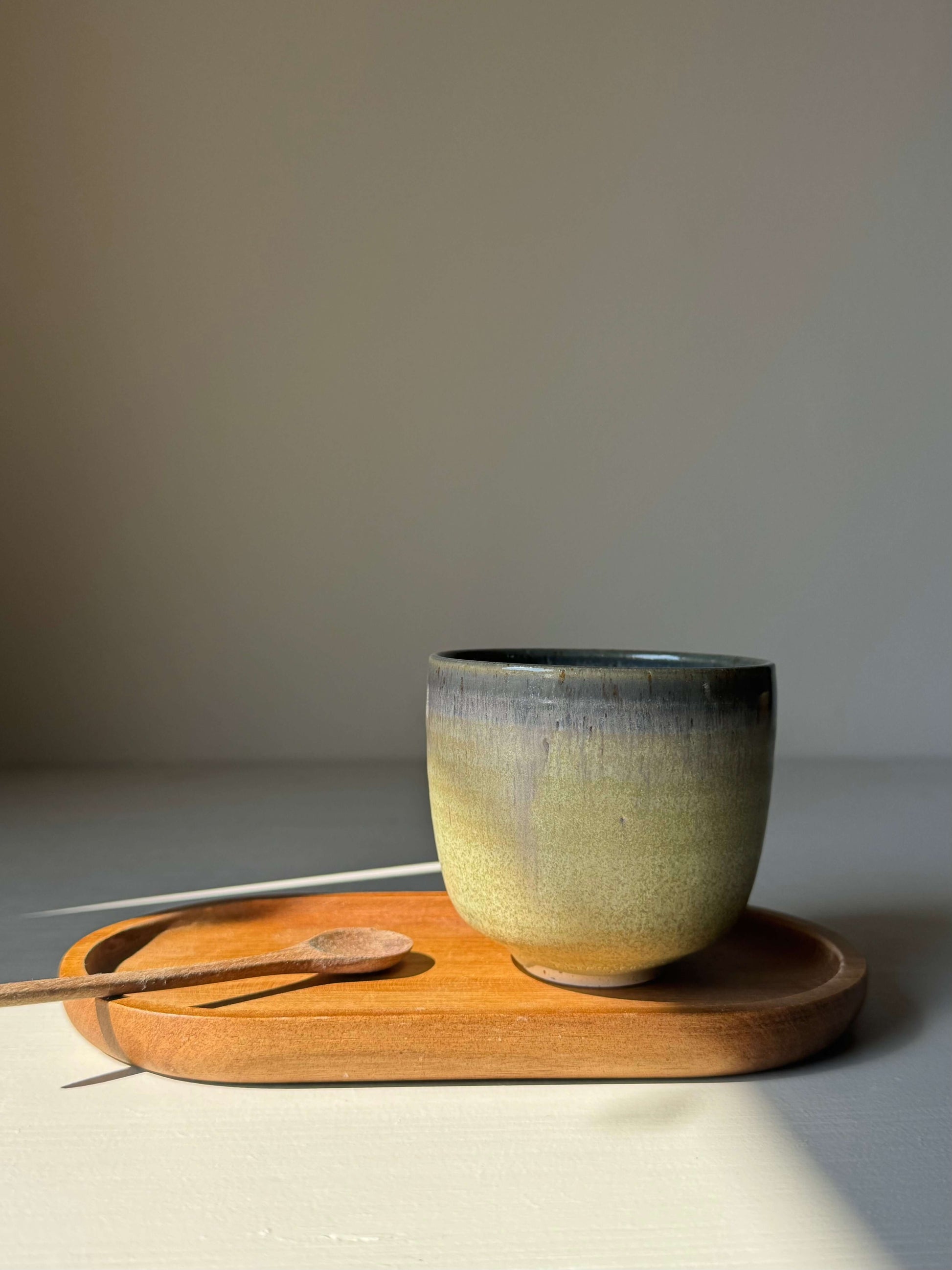 Handmade ceramic Cups - Satin Blue on wooden tray, misty grey to olive green glaze, rounded design, approx. 7.5 cm high x 8.5 cm wide.
