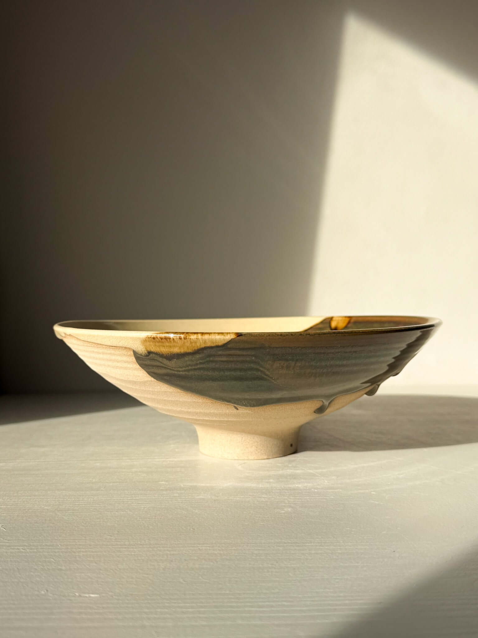 Serving Bowl - Inyo Series #01, handmade ceramic with contrasting glazes of tenmoku and amber, showcasing an organic, unique design.