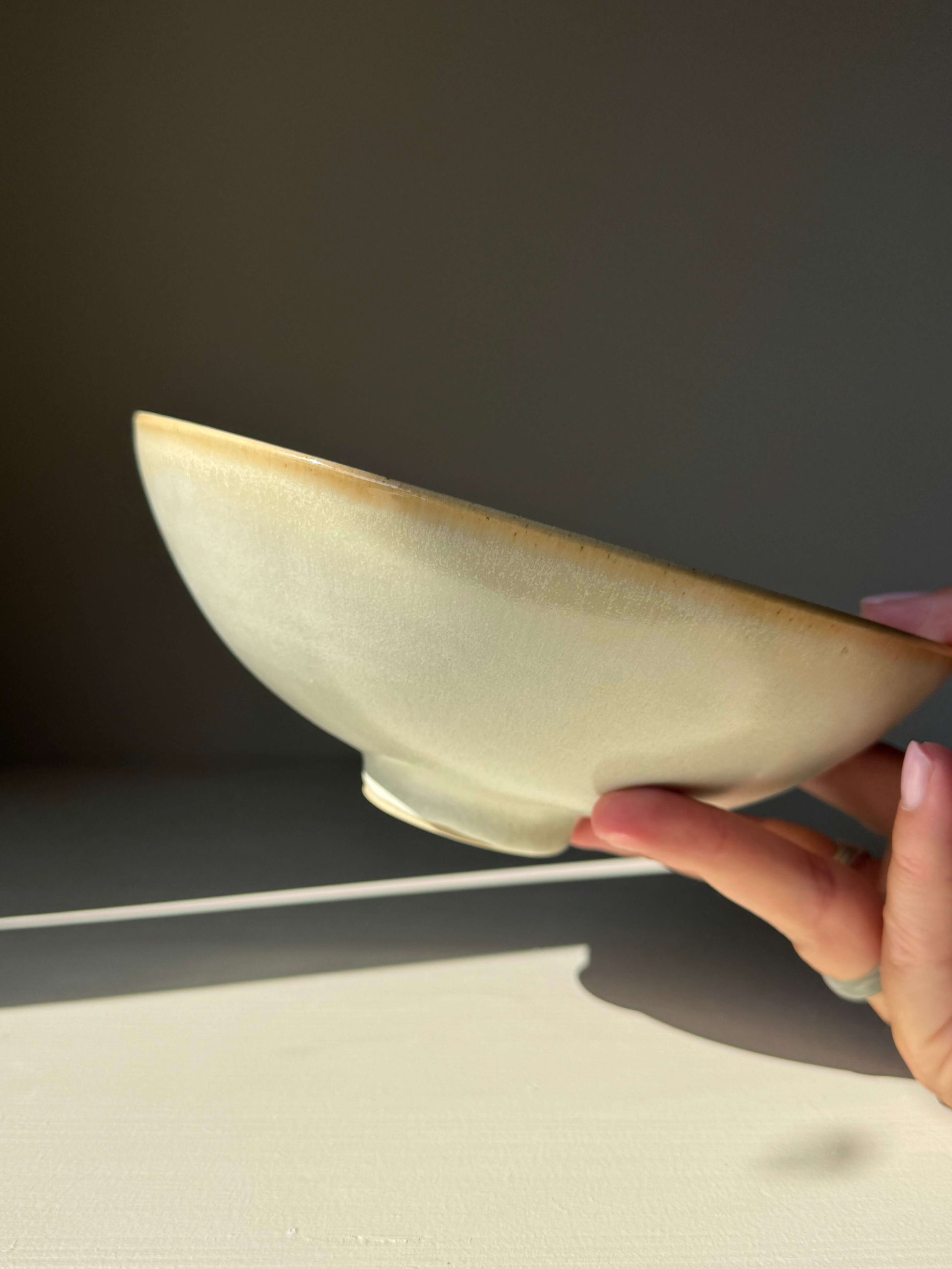 Handmade ceramic Shallow Dish - Moonstone with elegant moonstone glaze held by hand, showcasing its 7cm height and 19cm diameter.