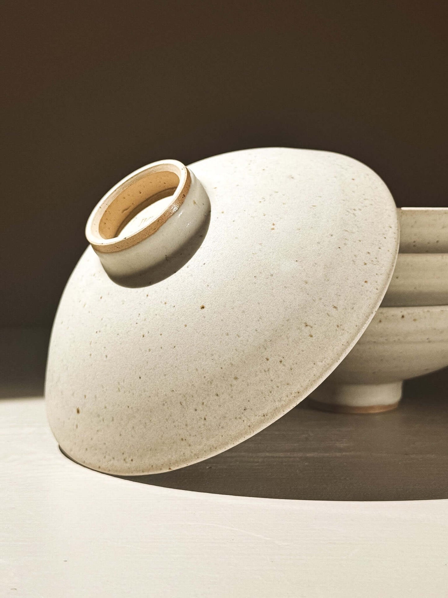 Small Footed Serving Bowl – Eggshell with a soft matte finish and speckled texture, showcasing its elegant design.