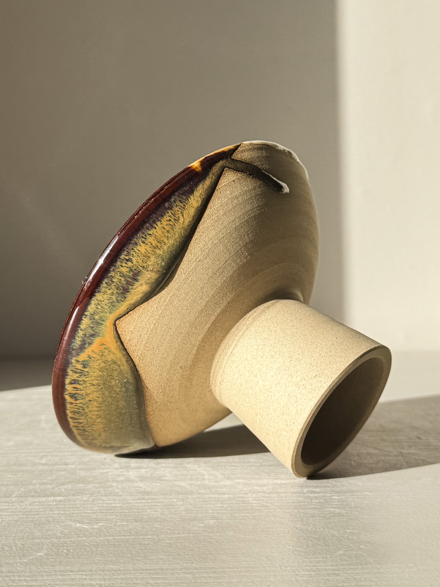 Small Pedestal Bowl - Inyo #01 with sculptural form and dripped glaze in warm gold, rich brown, blue, and green hues.