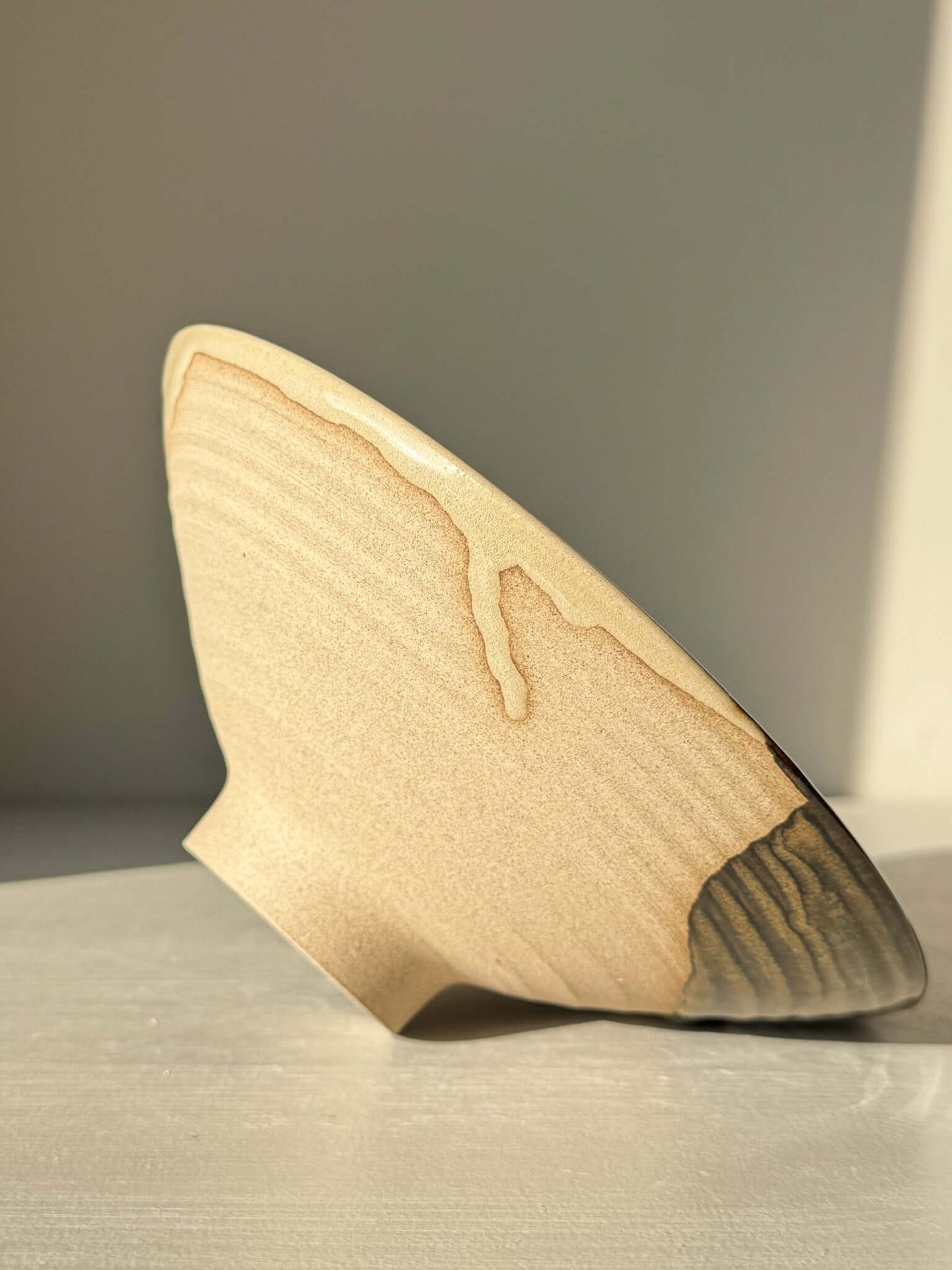 Handmade ceramic Small Serving Bowl - Inyo Series #01 with contrasting tenmoku and amber glaze, showcasing raw clay base.