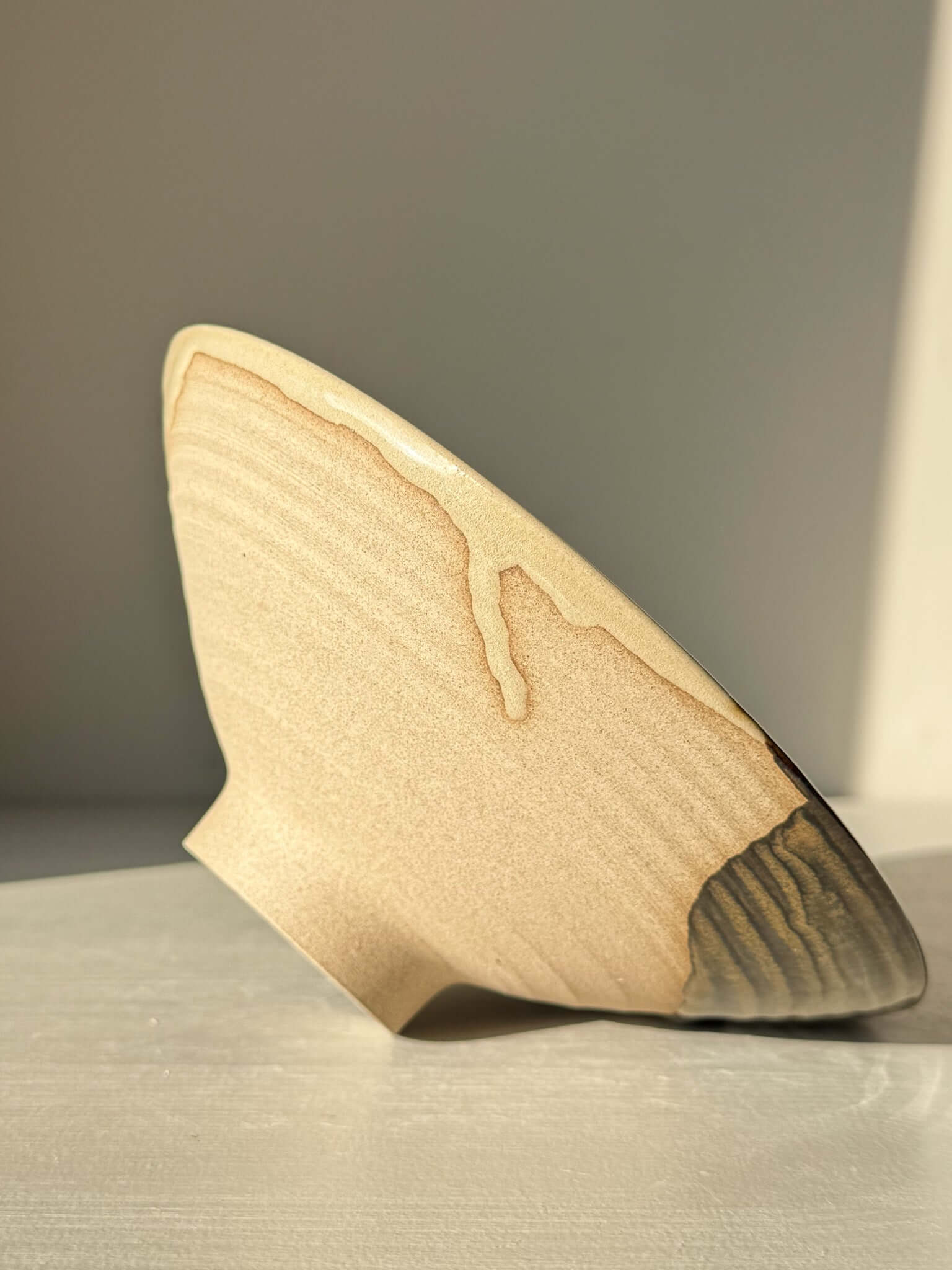 Handmade ceramic Small Serving Bowl - Inyo Series #01 with contrasting tenmoku and amber glaze, showcasing raw clay base.