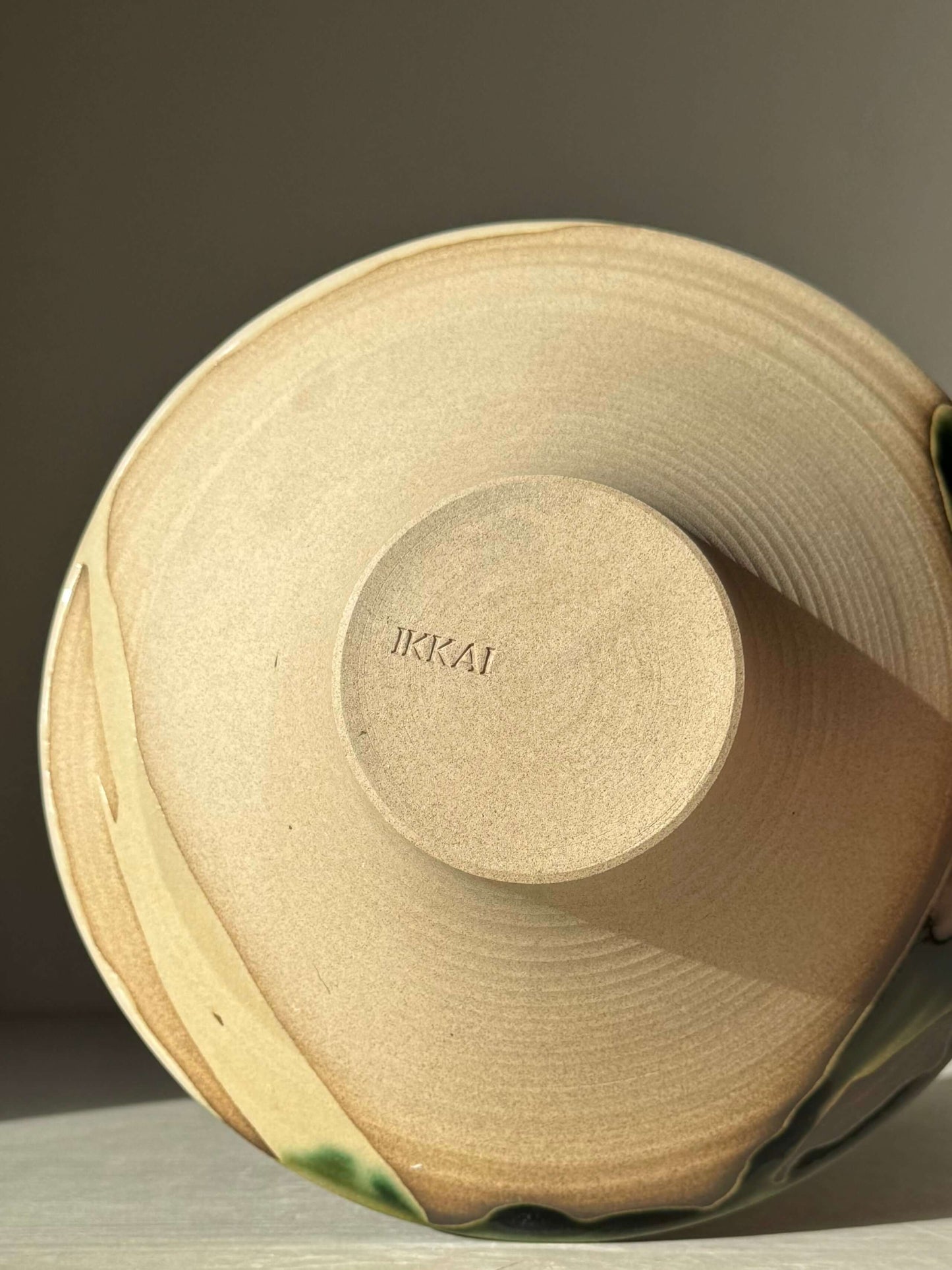 Base view of Small Serving Bowl - Mori #01 handmade ceramic with toffee clay and green glaze detailing.