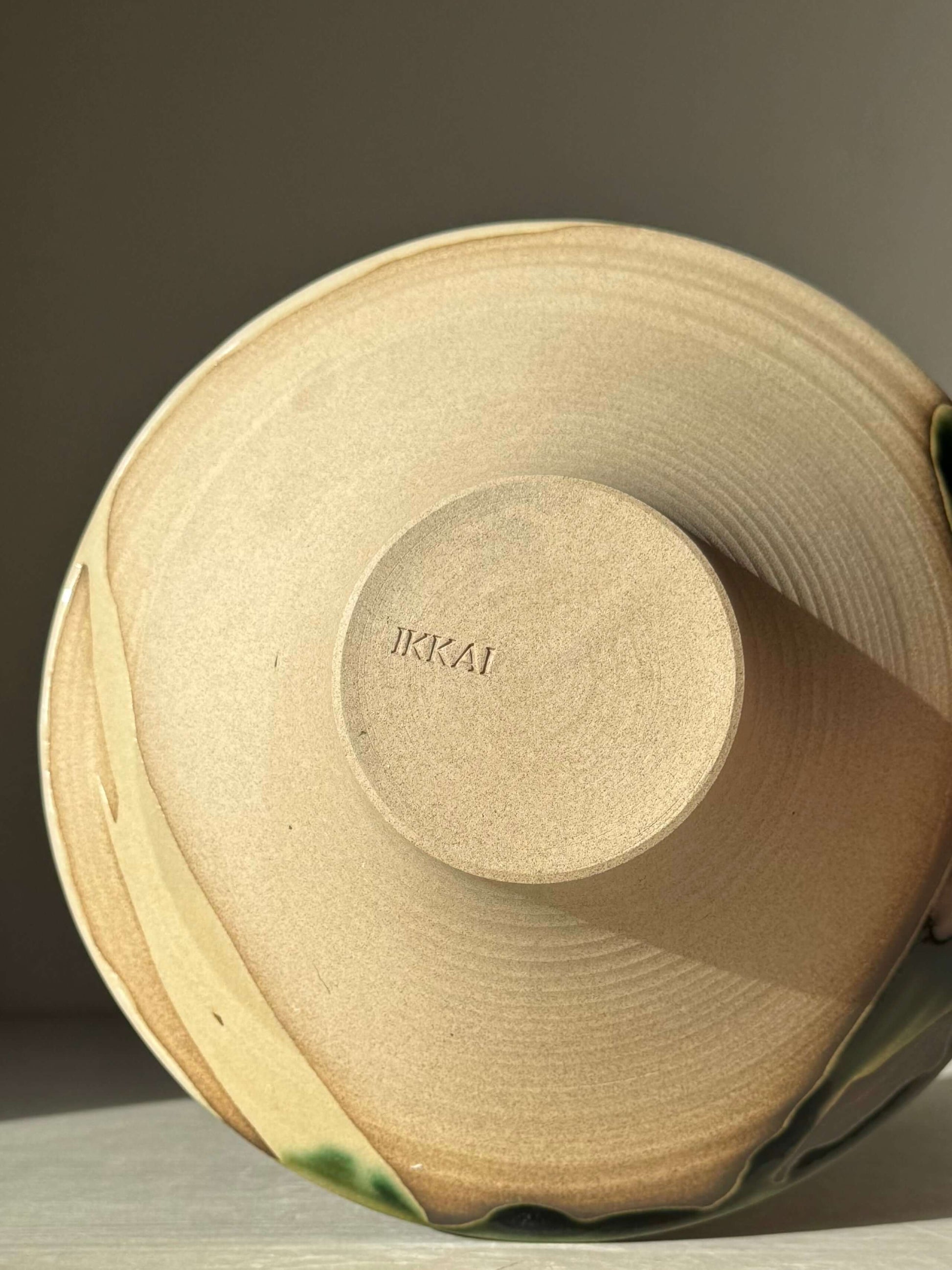 Base view of Small Serving Bowl - Mori #01 handmade ceramic with toffee clay and green glaze detailing.