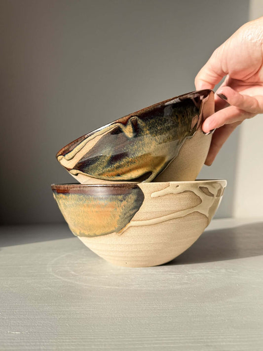 Two handmade ceramic bowls from Soup Bowl – Inyo Series being stacked, showcasing toffee-colored stoneware.