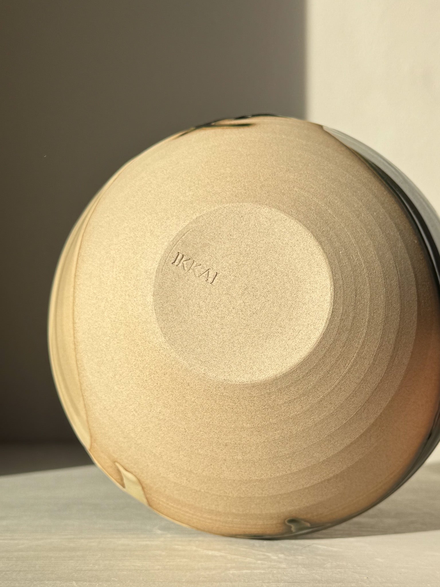 Underside view of a Soup Bowl – Mori Series in toffee-colored stoneware, showcasing its wheel-thrown craftsmanship.