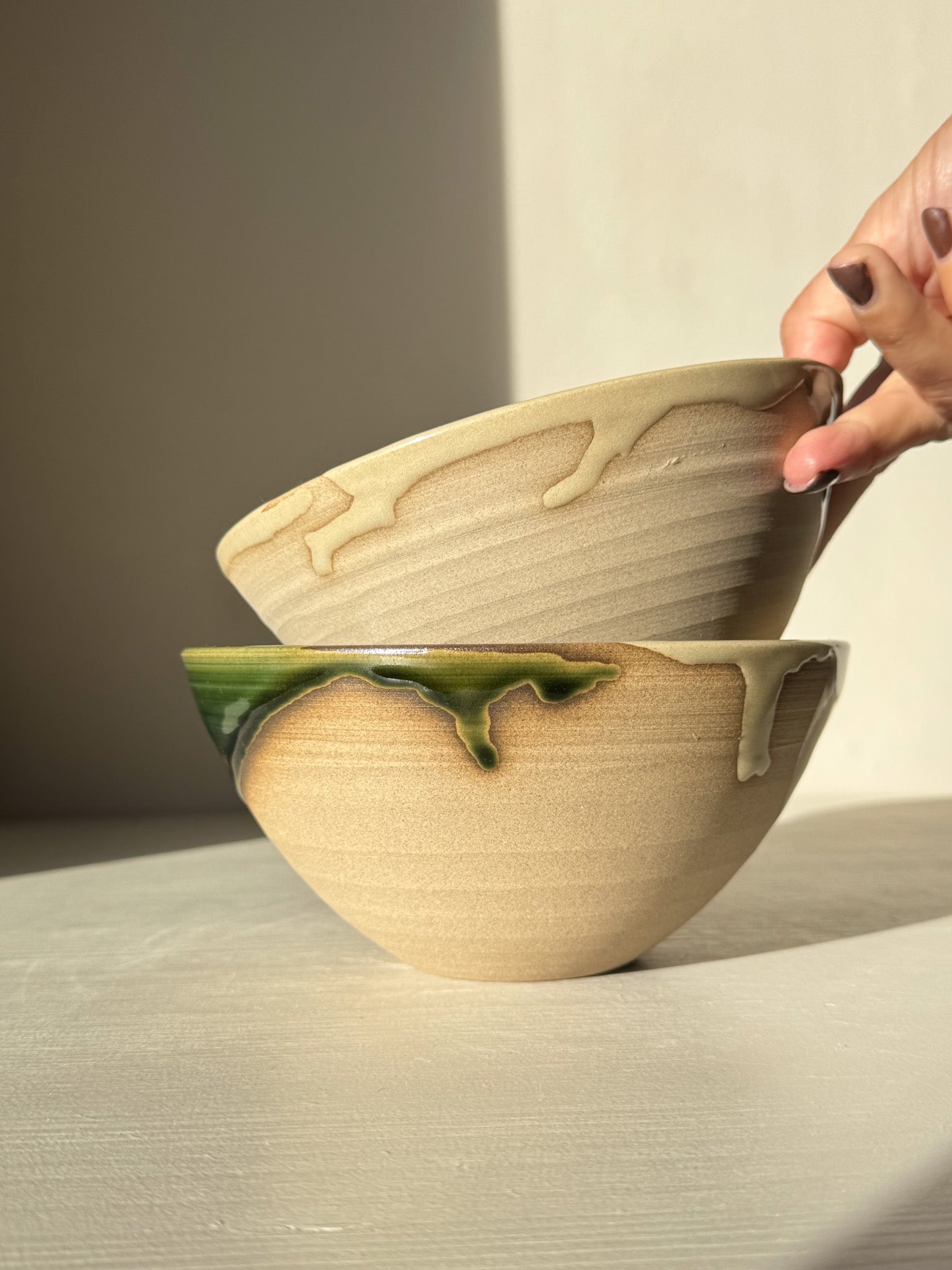 Hand holding stack of Soup Bowl – Mori Series pottery with organic design, perfect for daily meals.