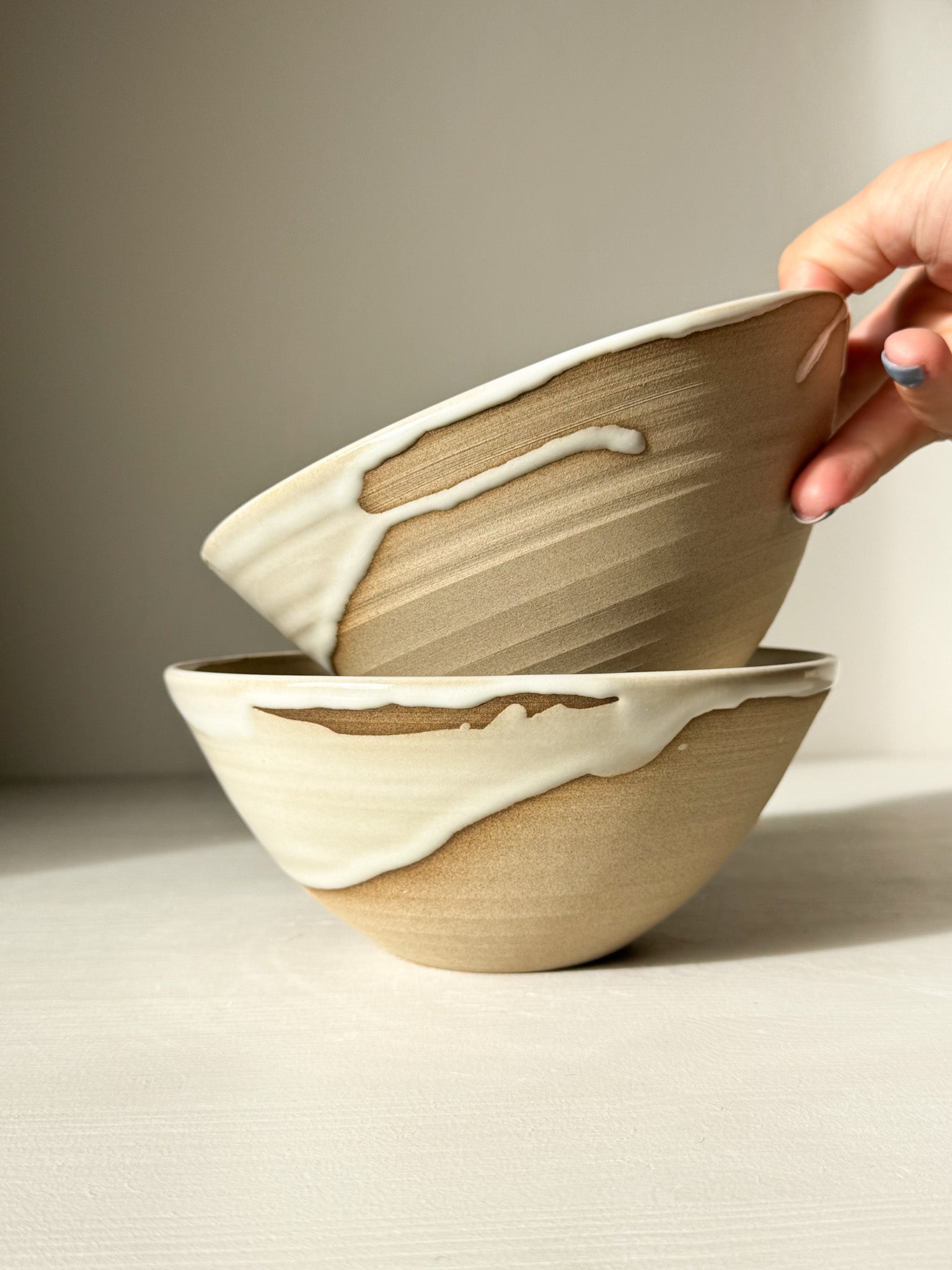 Hand holding elegant wheel-thrown Soup Bowl – Yuki, showcasing minimalist design with natural glaze, perfect for soup or rice.