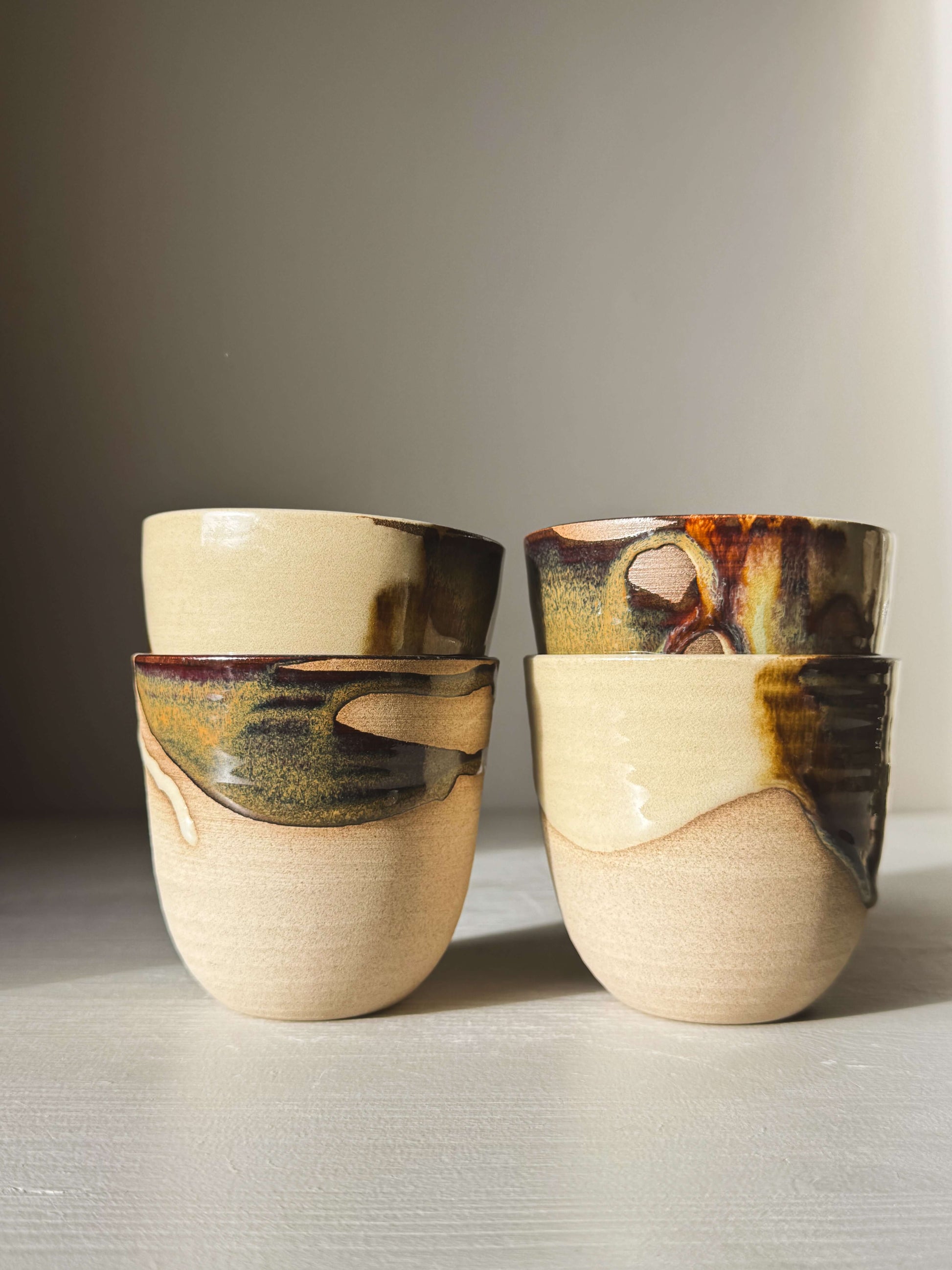 Stackable Latte Cups - Inyo with unique tenmoku and clear glazes, handcrafted and perfect for everyday use, shown neatly stacked.