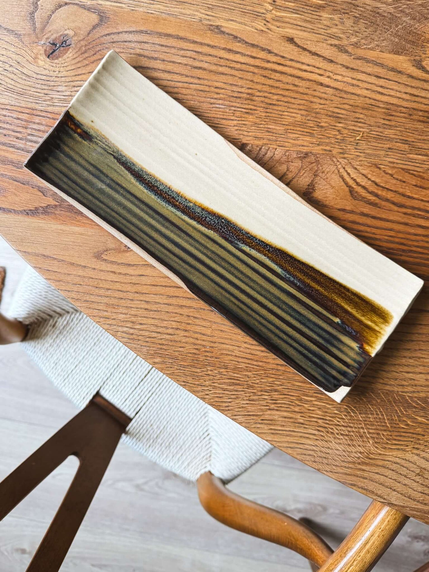 Handcrafted Sushi Plate – Inyo #01 with tenmoku glaze on a wooden table