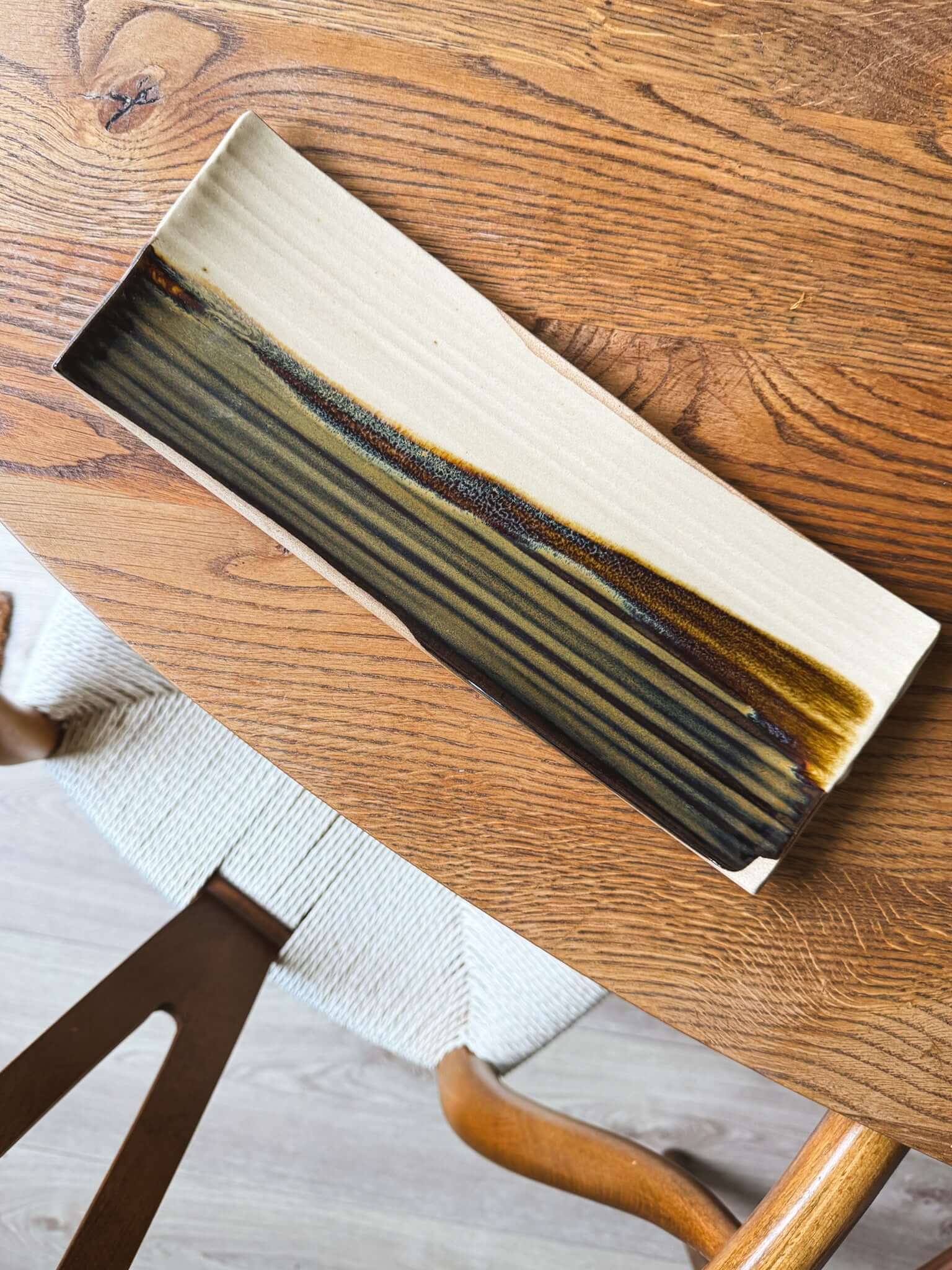 Handcrafted Sushi Plate – Inyo #01 with tenmoku glaze on a wooden table