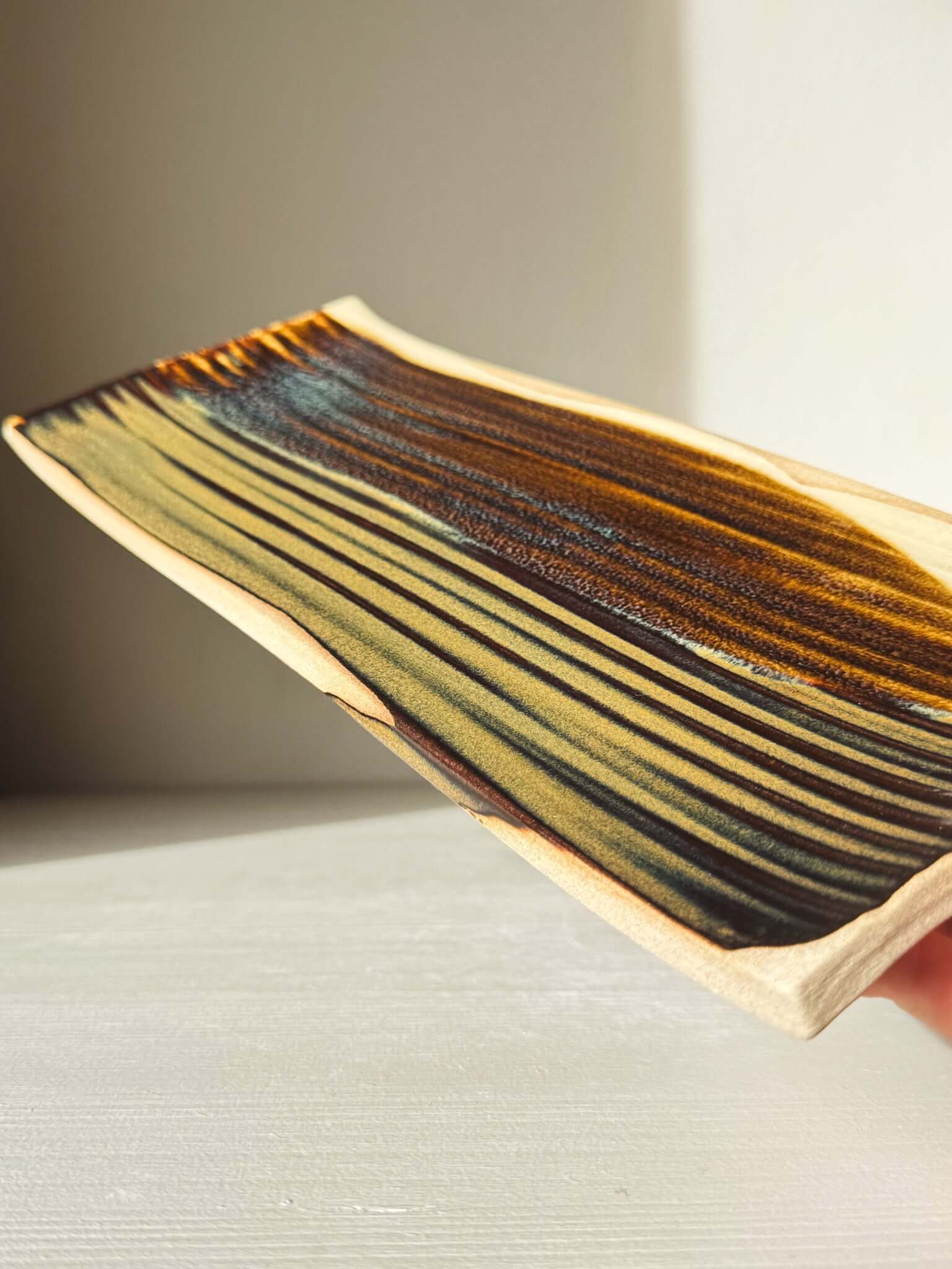 Sushi Plate – Inyo #02 with unique tenmoku glazing and soft curves, crafted from a wheel-thrown cylinder, size approx. 33cm x 13cm.