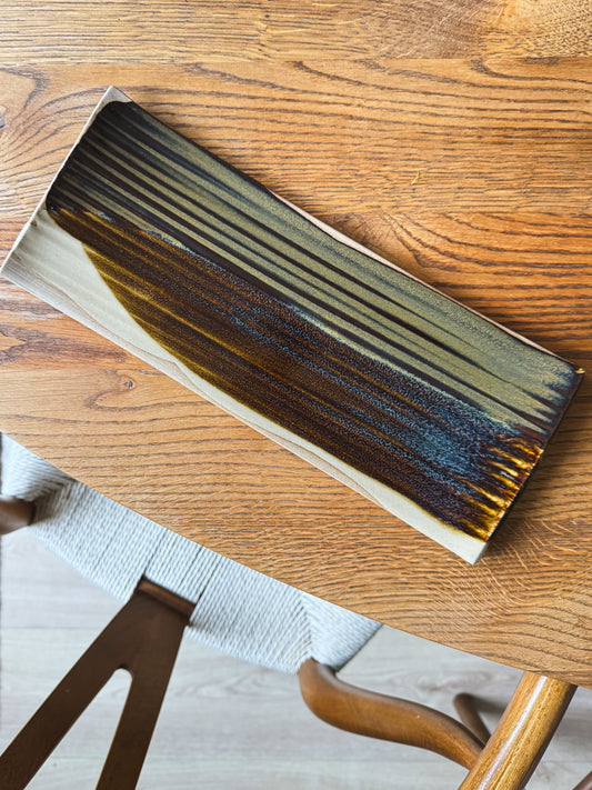 Sushi Plate – Inyo #02 resting on wooden table, featuring unique tenmoku and clear glaze design, approx. 33cm x 13cm size.