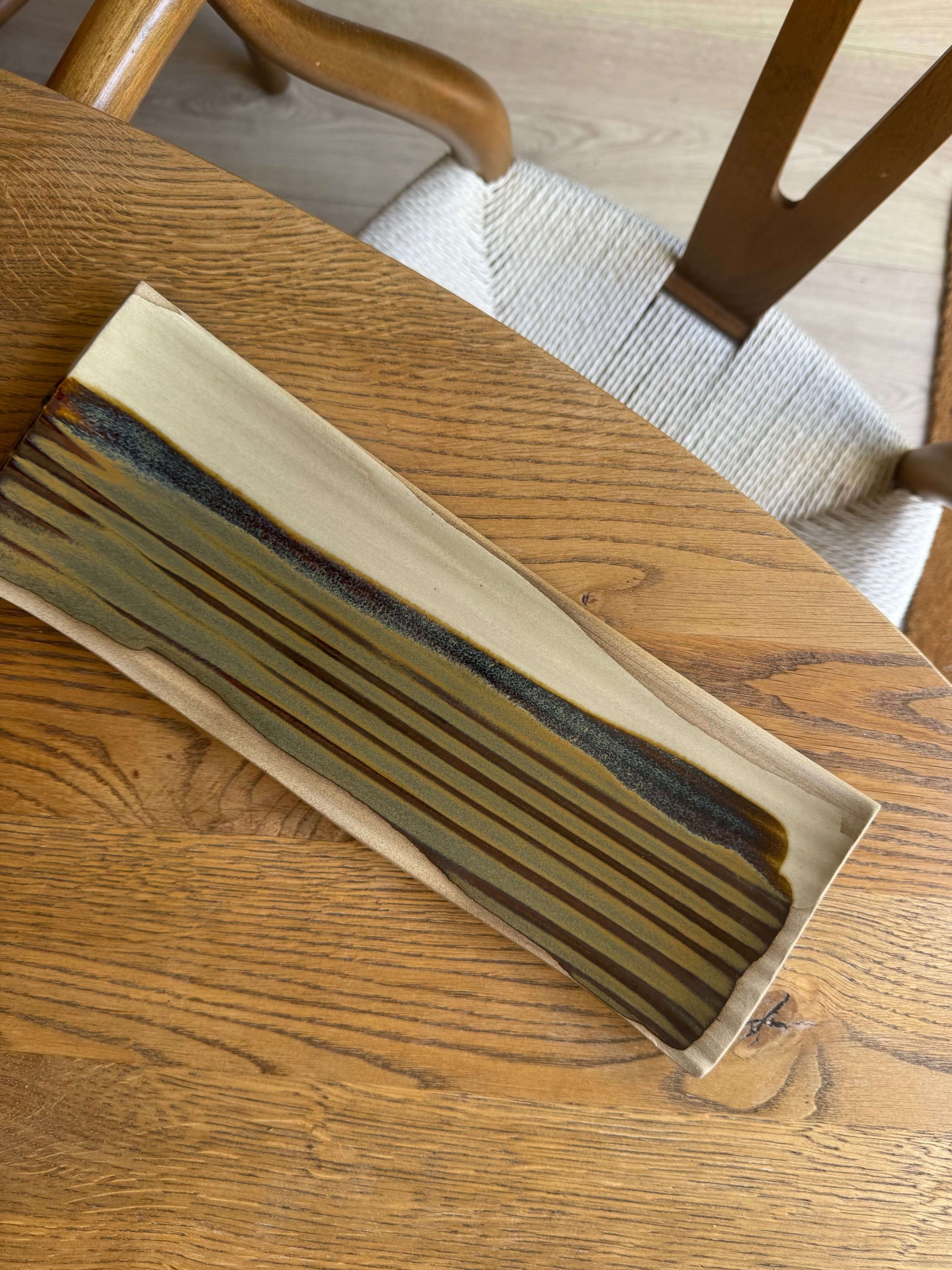 Handmade ceramic Sushi Plate – Inyo Series #01 with tenmoku glaze, showcasing unique design and soft curves, 34cm x 11.5cm.