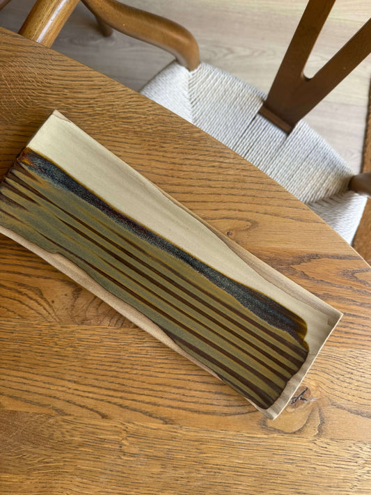 Handmade ceramic Sushi Plate – Inyo Series #01 with tenmoku glaze, showcasing unique design and soft curves, 34cm x 11.5cm.