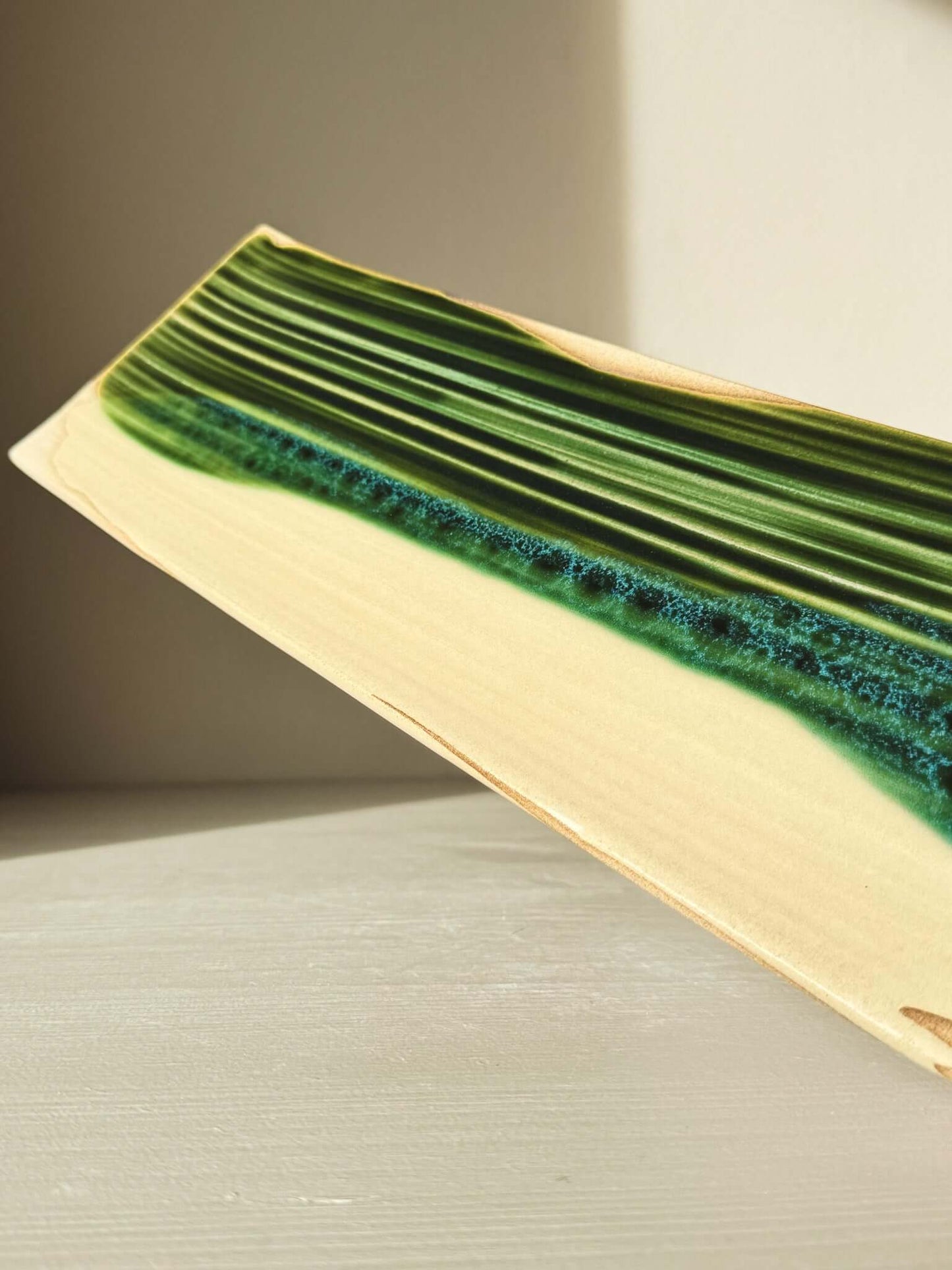 Rectangular Sushi Plate – Mori #01 with unique green glaze, handcrafted from clay. Approx. size: 36cm x 12cm. Shown on a light surface.