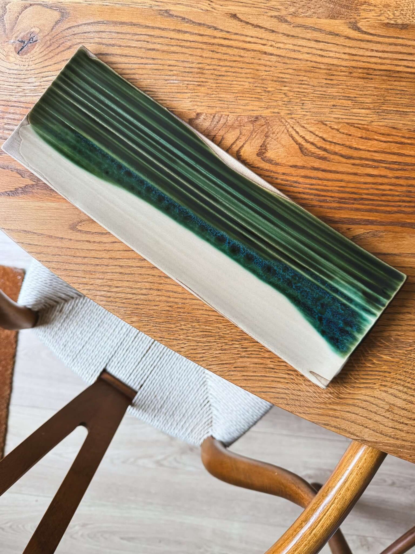 Sushi Plate – Mori #01 with unique flowing green glaze on a wooden table