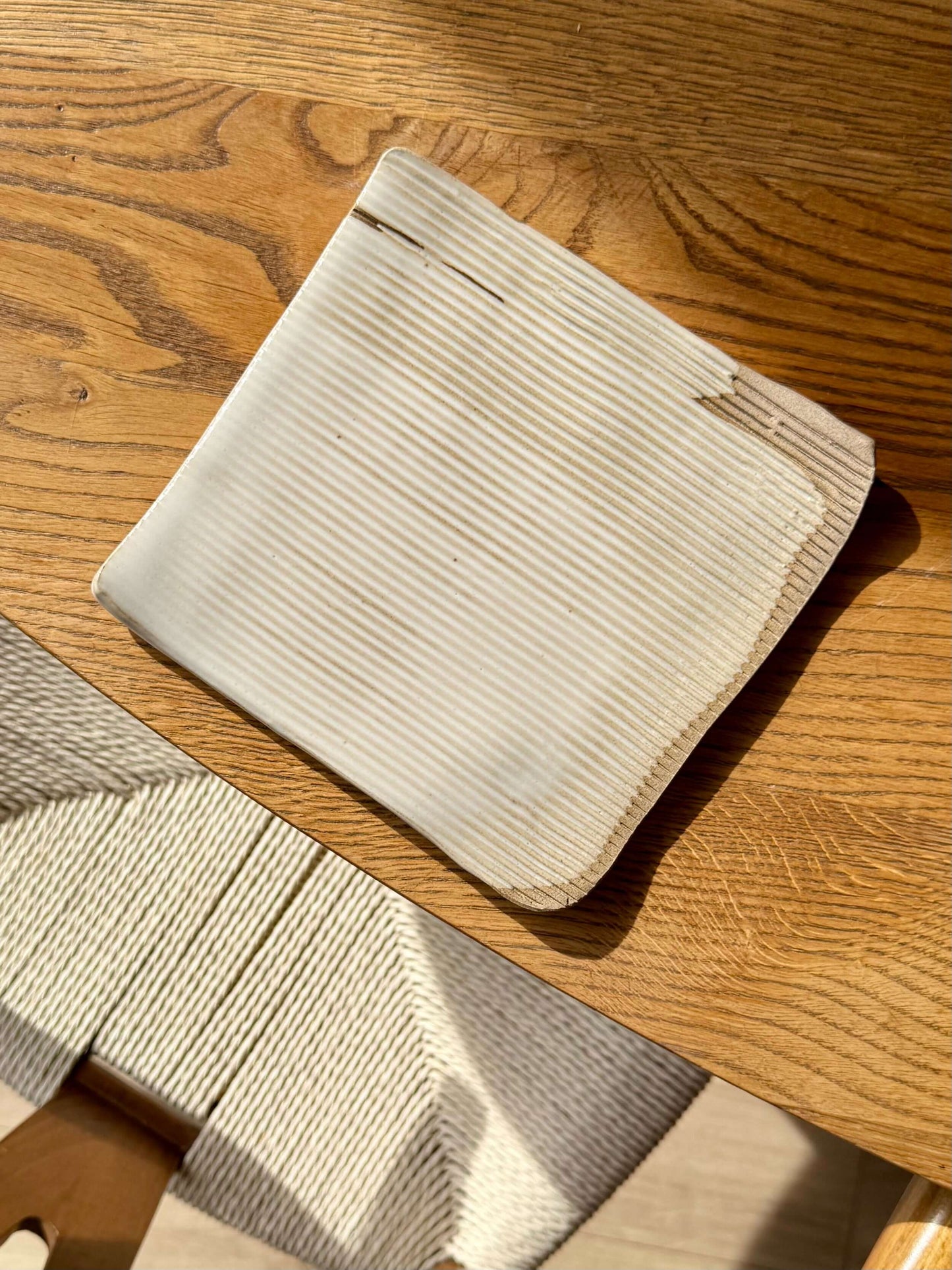 Handmade ceramic Sushi Plate – Yuki #01 with elegant ridges and glossy white glaze, perfect for enhancing dining experiences.