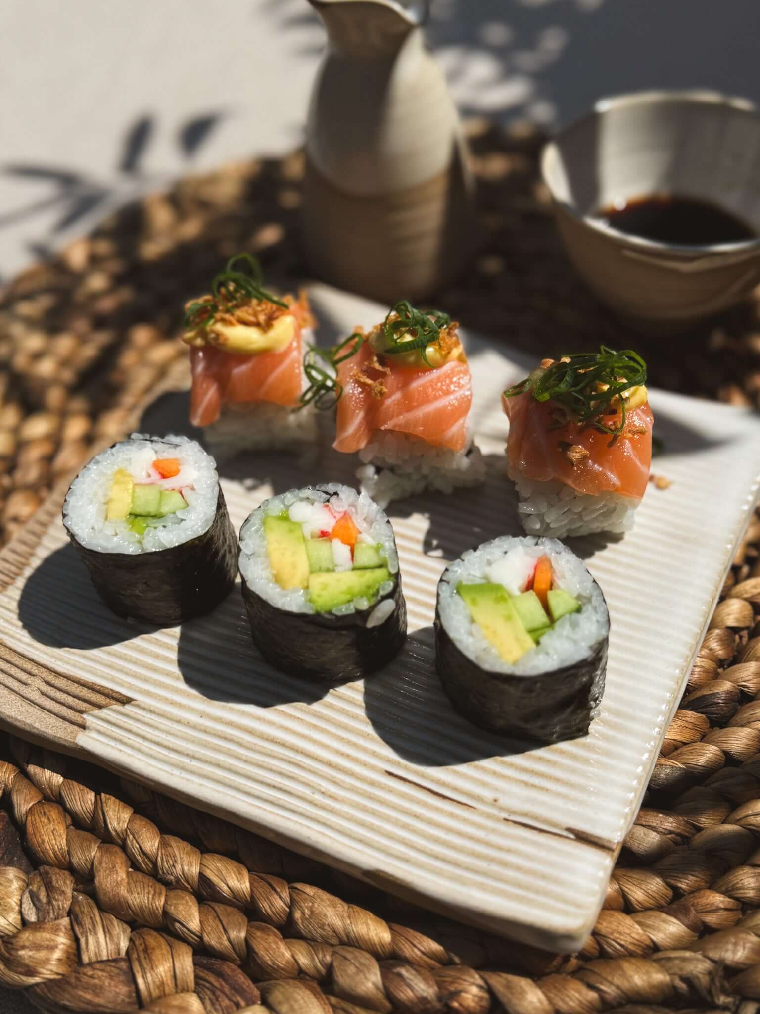 Sushi Plate – Yuki Series #01 with handmade ceramic design featuring sushi rolls and nigiri on a woven mat.