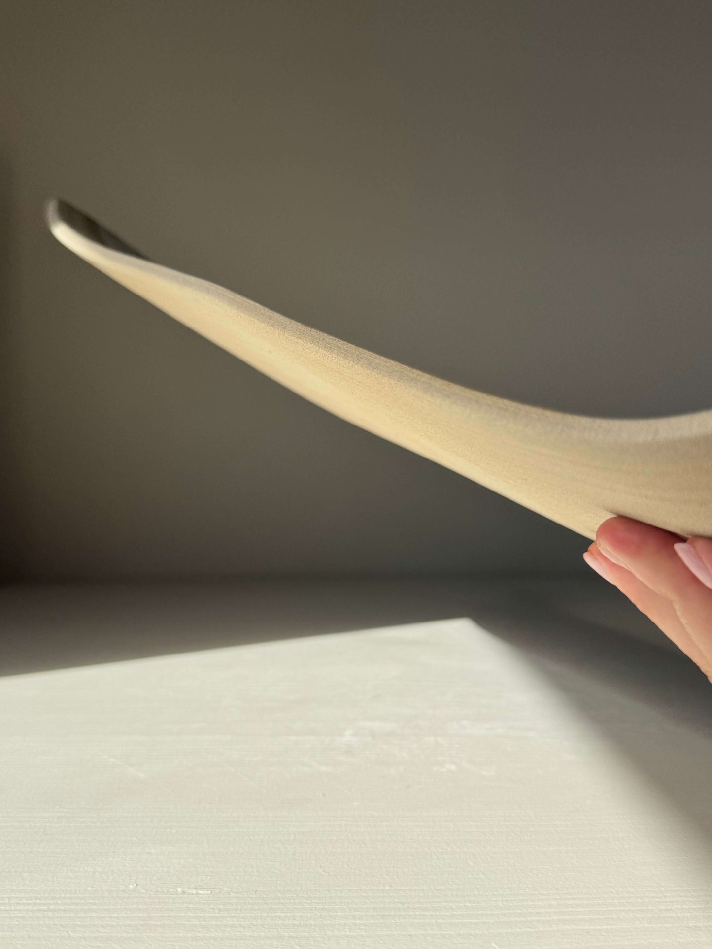 Side view of handmade ceramic Sushi Plate – Yuki Series #02 showcasing its unique shape and texture.