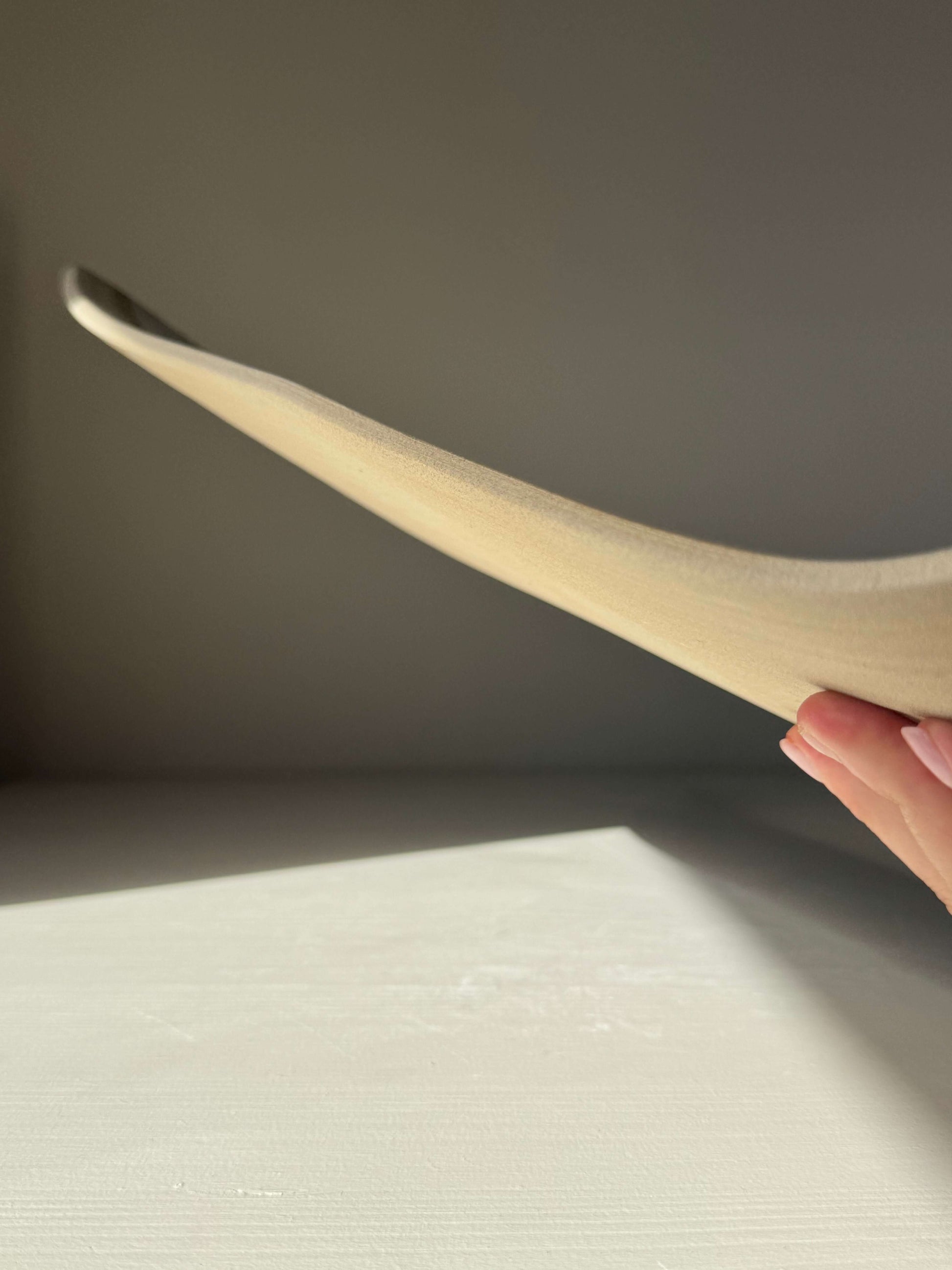 Side view of handmade ceramic Sushi Plate – Yuki Series #02 showcasing its unique shape and texture.