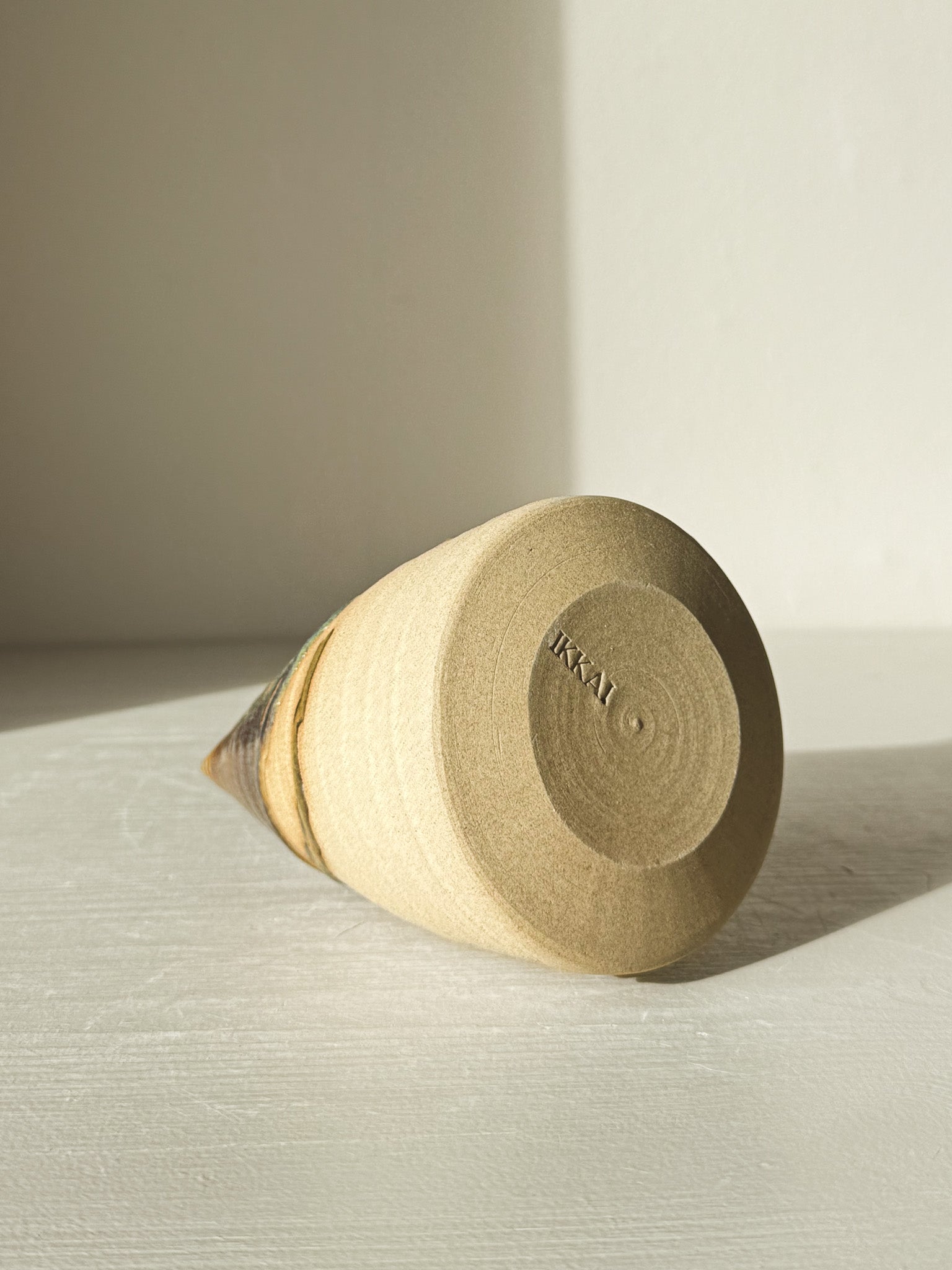 Bottom view of Textured Ceramic Tree – Inyo #02 with visible throwing lines and tenmoku glaze detail.