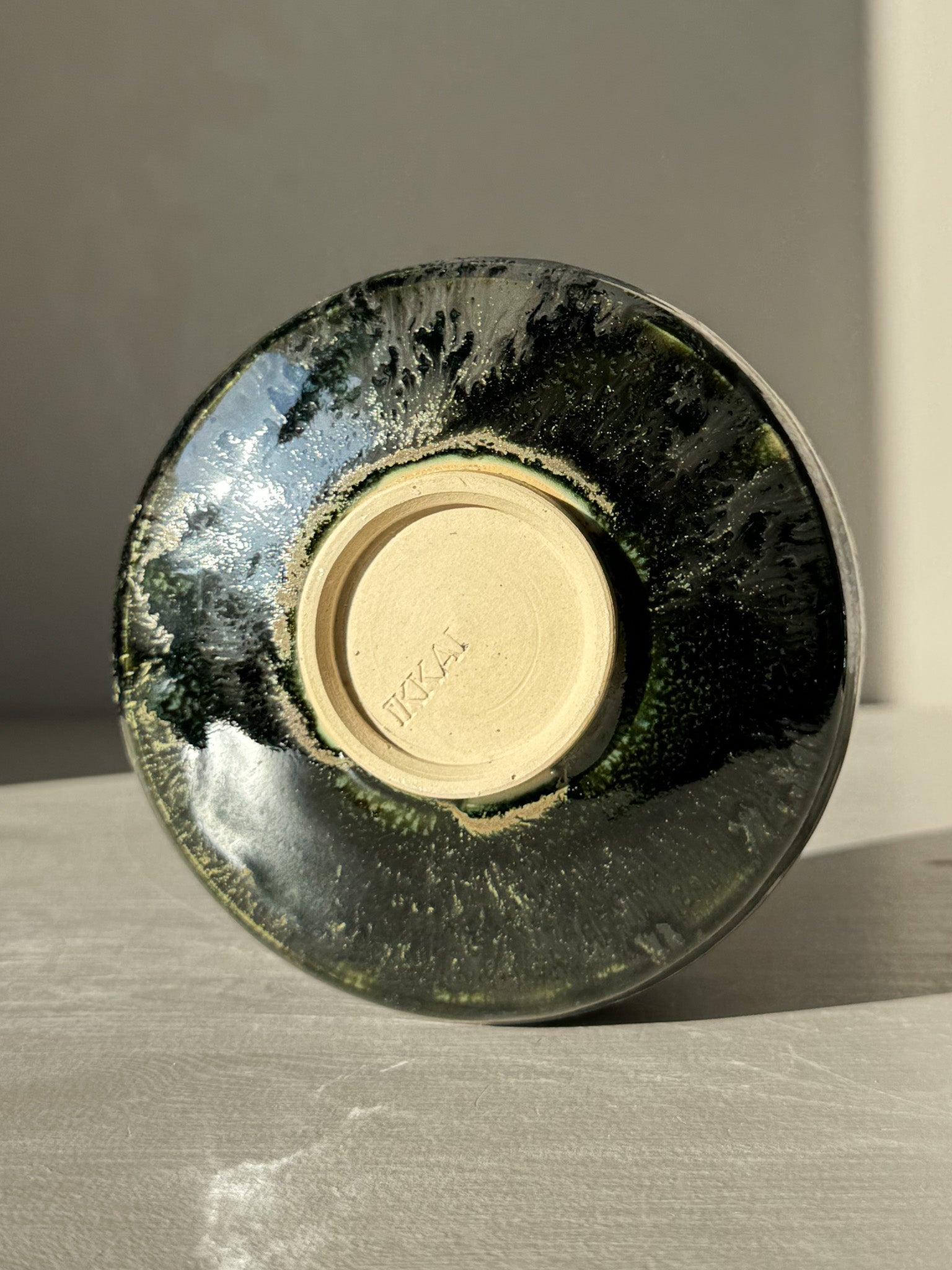 Bottom view of Textured Matcha Bowl Spout - Hinoki #05 with glossy green glaze and visible texture.
