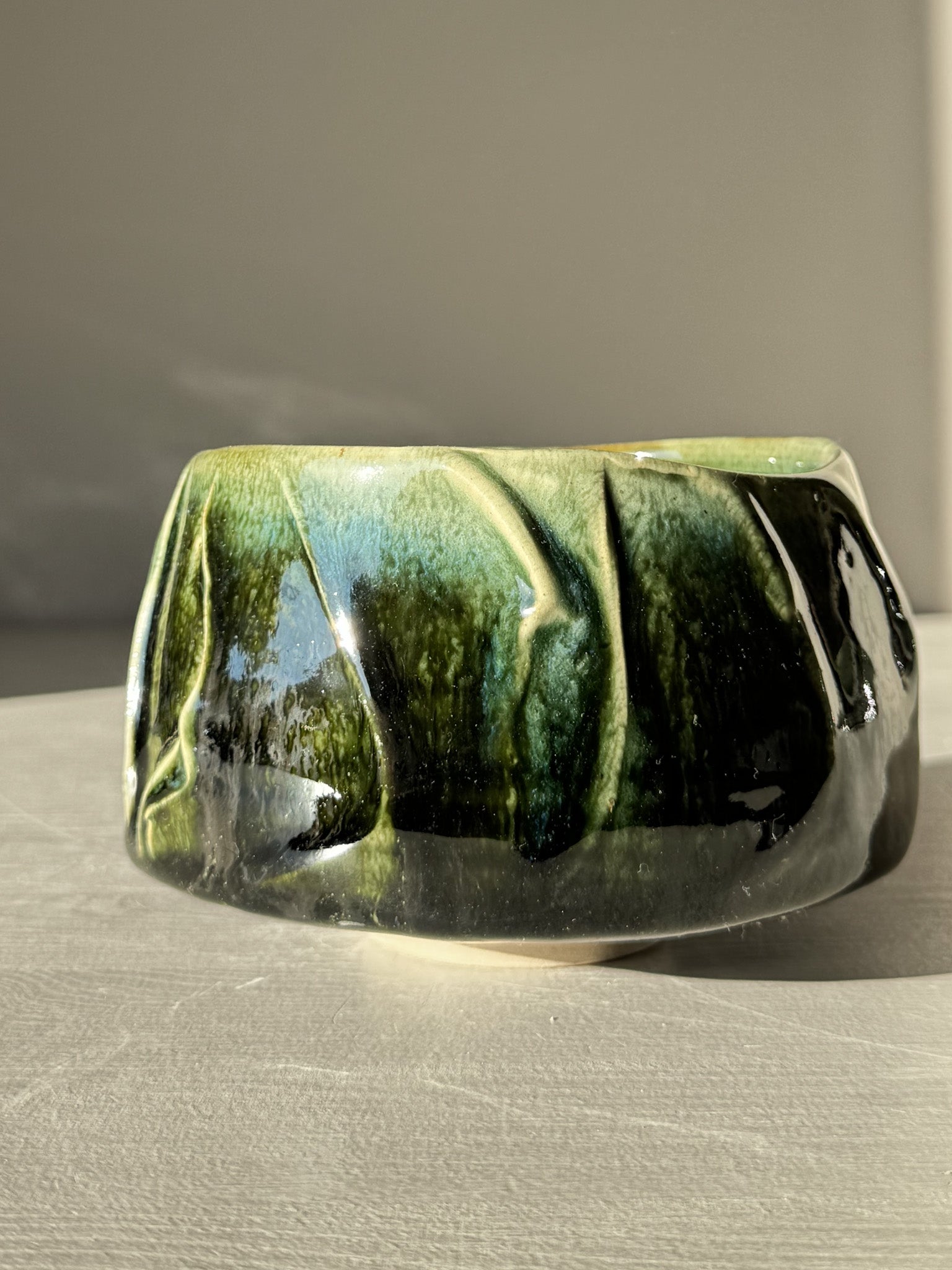 Textured Matcha Bowl - Hinoki #16 with green glaze and unique textured finish, inspired by Hinoki tree hues, resting on a table.