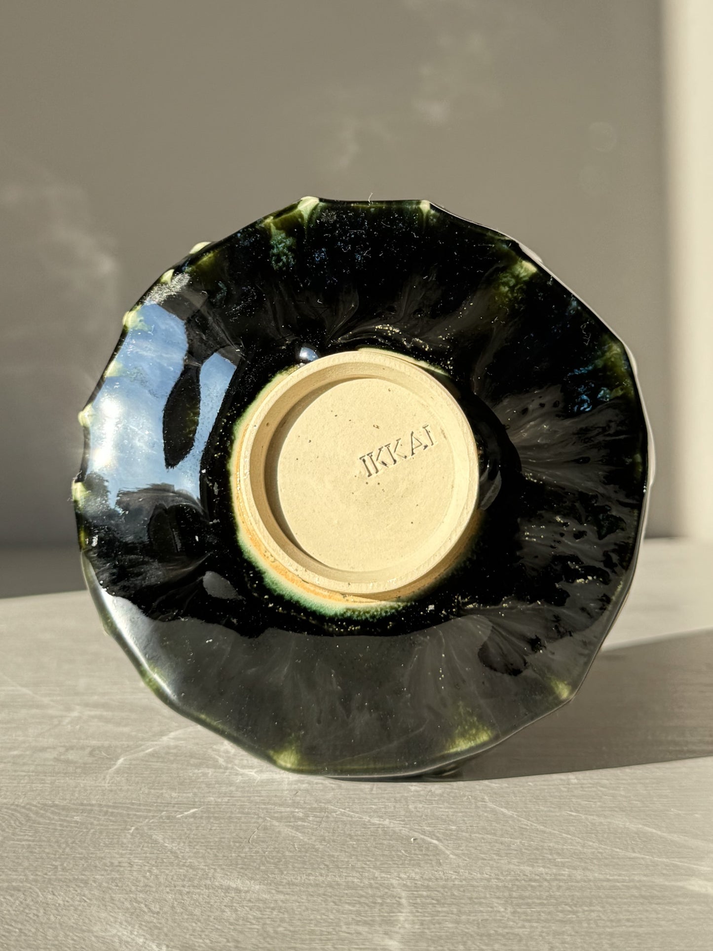 Bottom view of Textured Matcha Bowl - Hinoki #12 with green glaze and unique textured finish.