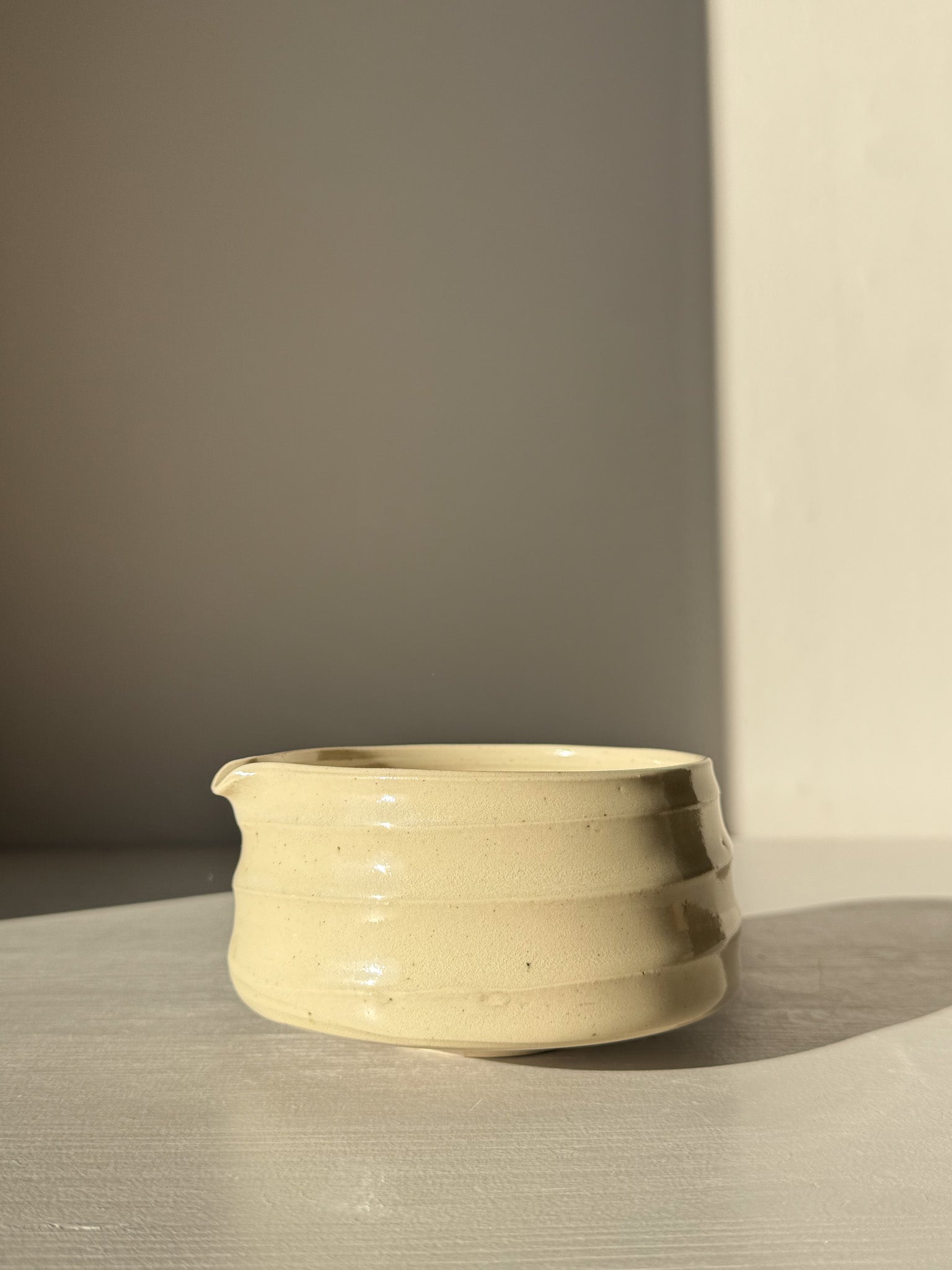 Textured Matcha Bowl Spout - Clear #01 featuring soft rounded form with clear glossy glaze, highlighting stoneware texture and pouring spout.