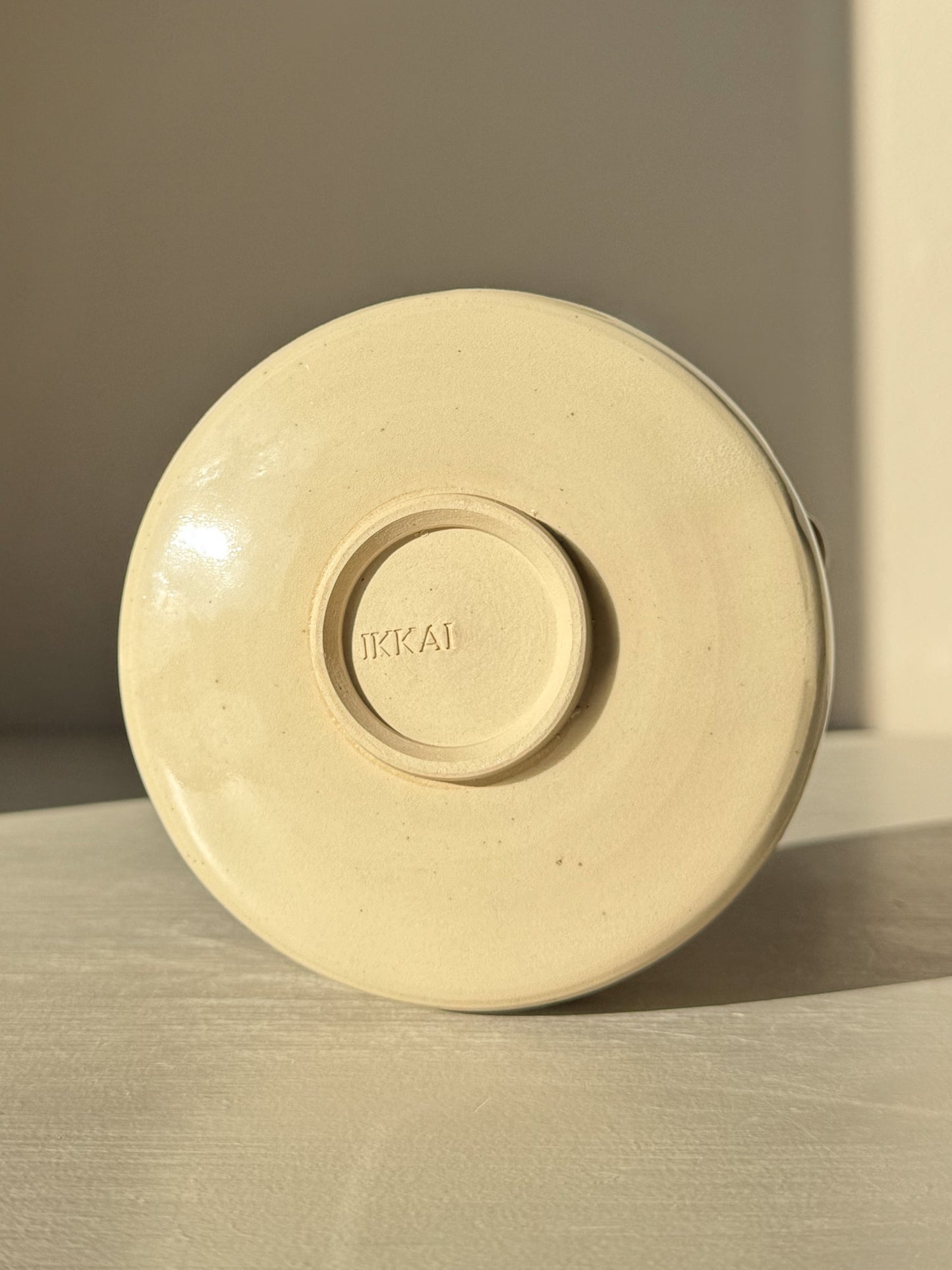 Base view of Textured Matcha Bowl Spout - Clear #01 showcasing stoneware clay and round form