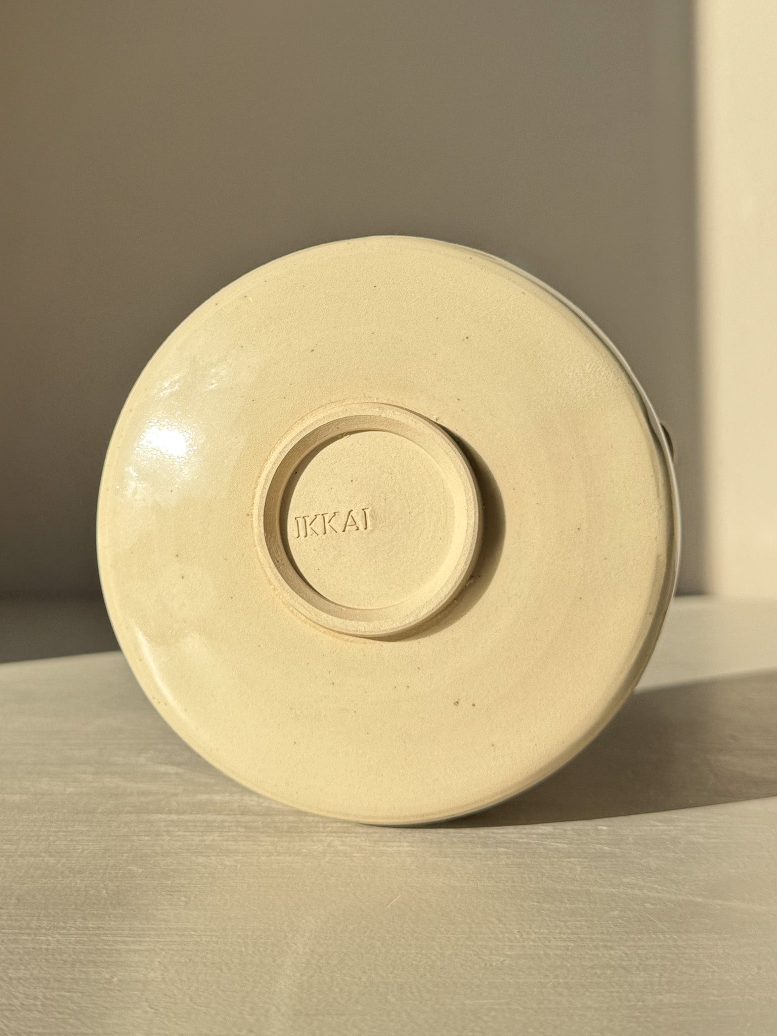 Base view of Textured Matcha Bowl Spout - Clear #01 showcasing stoneware clay and round form