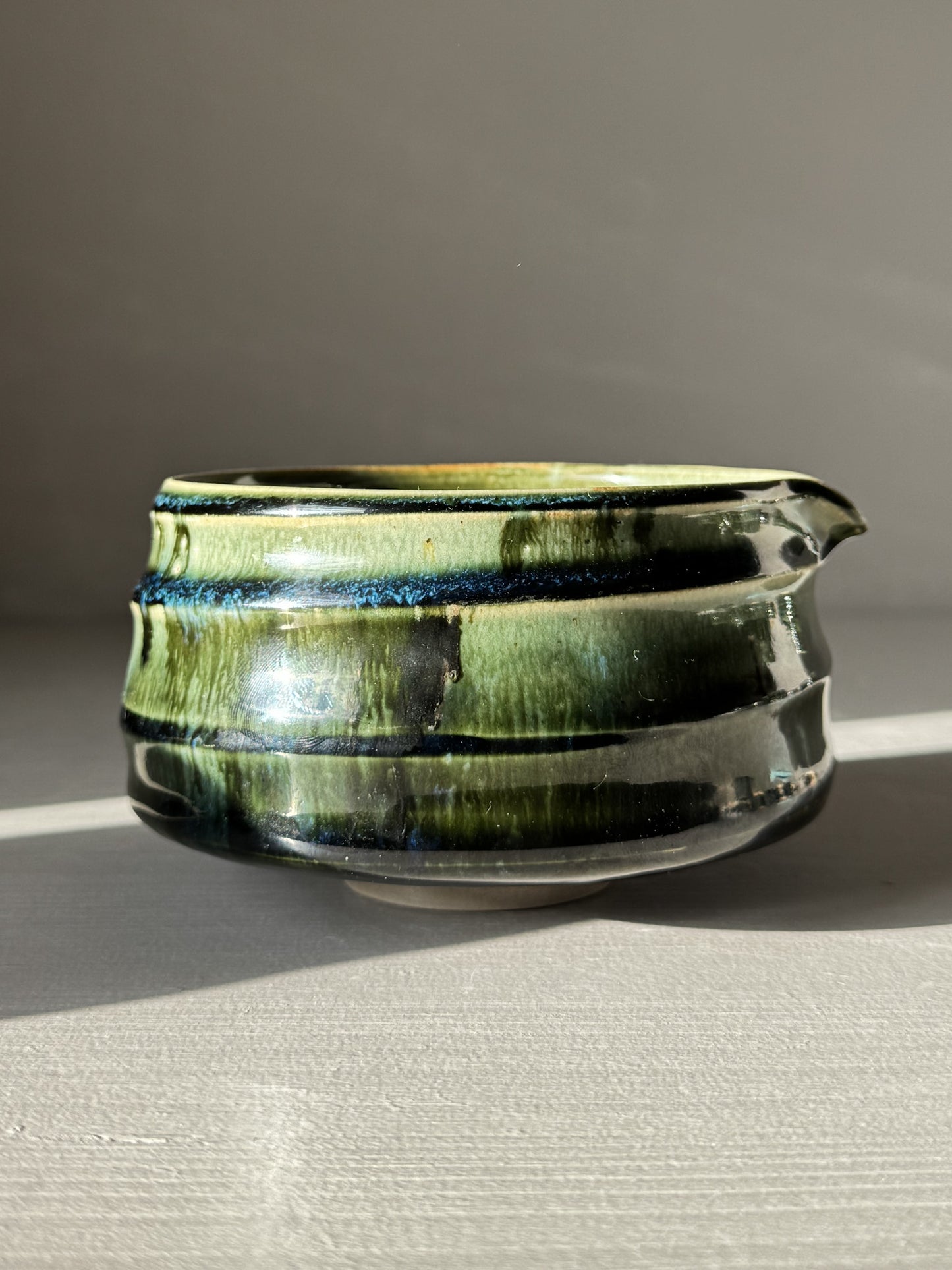 Textured Matcha Bowl Spout - Hinoki #02 in green glossy glaze with pouring spout and tactile ridges, highlighting ceramic craftsmanship.