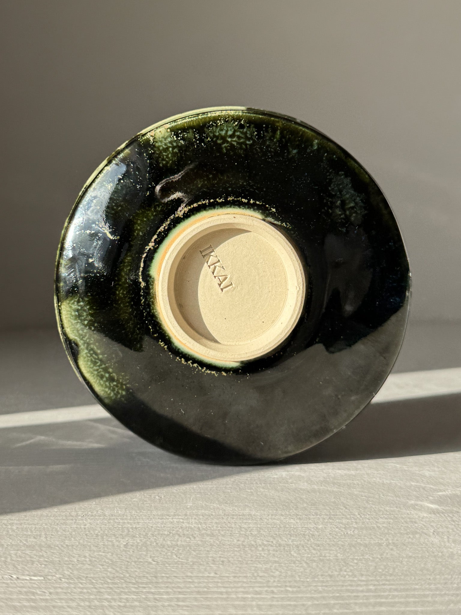 Bottom view of Textured Matcha Bowl Spout - Hinoki #02 with glossy green glaze and visible throwing lines.