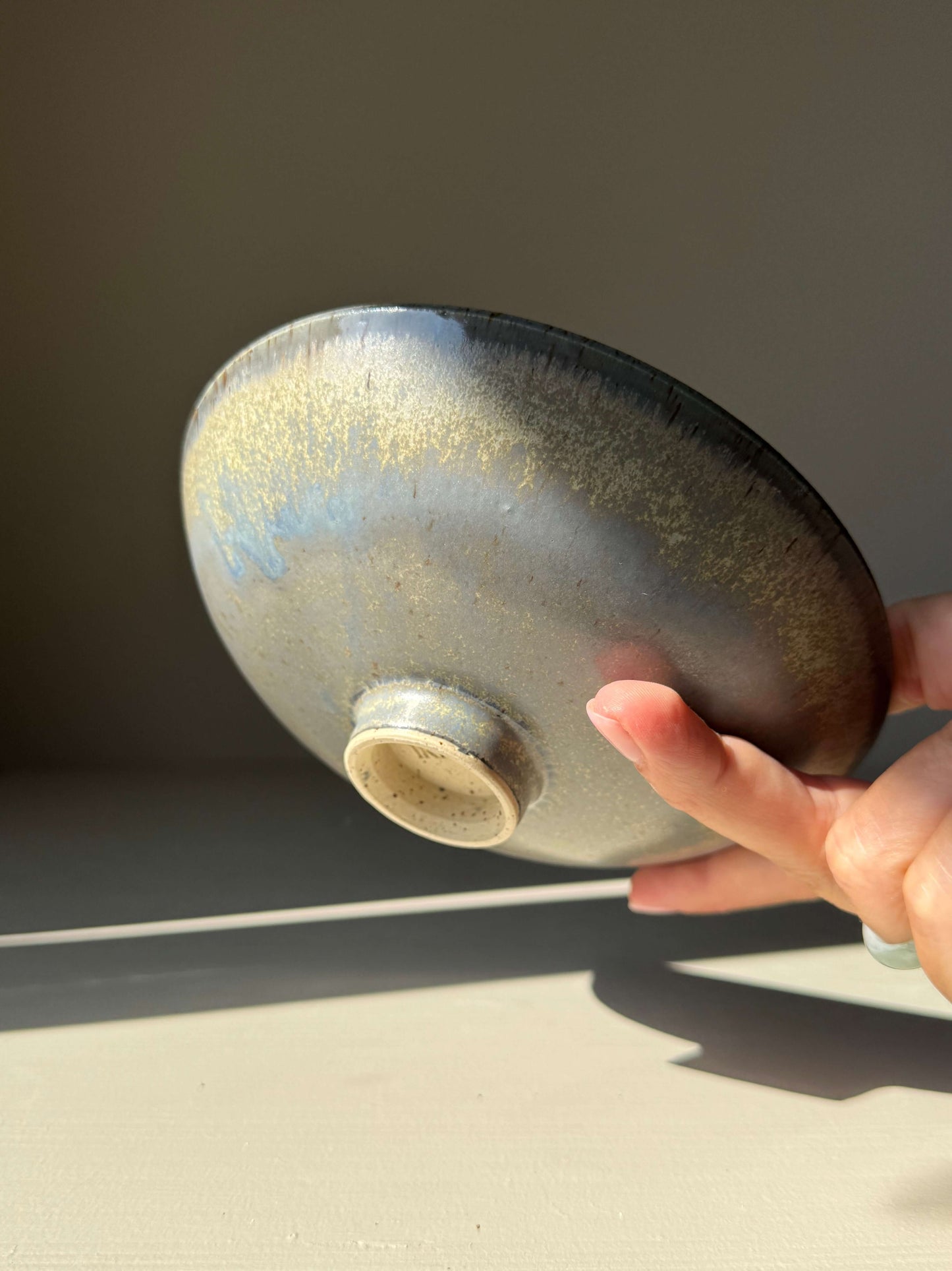 Trinket Dish - Satin Blue handmade ceramic with satin blue glaze, 15cm diameter, elegant high-fired stoneware seen from below, sunny background.