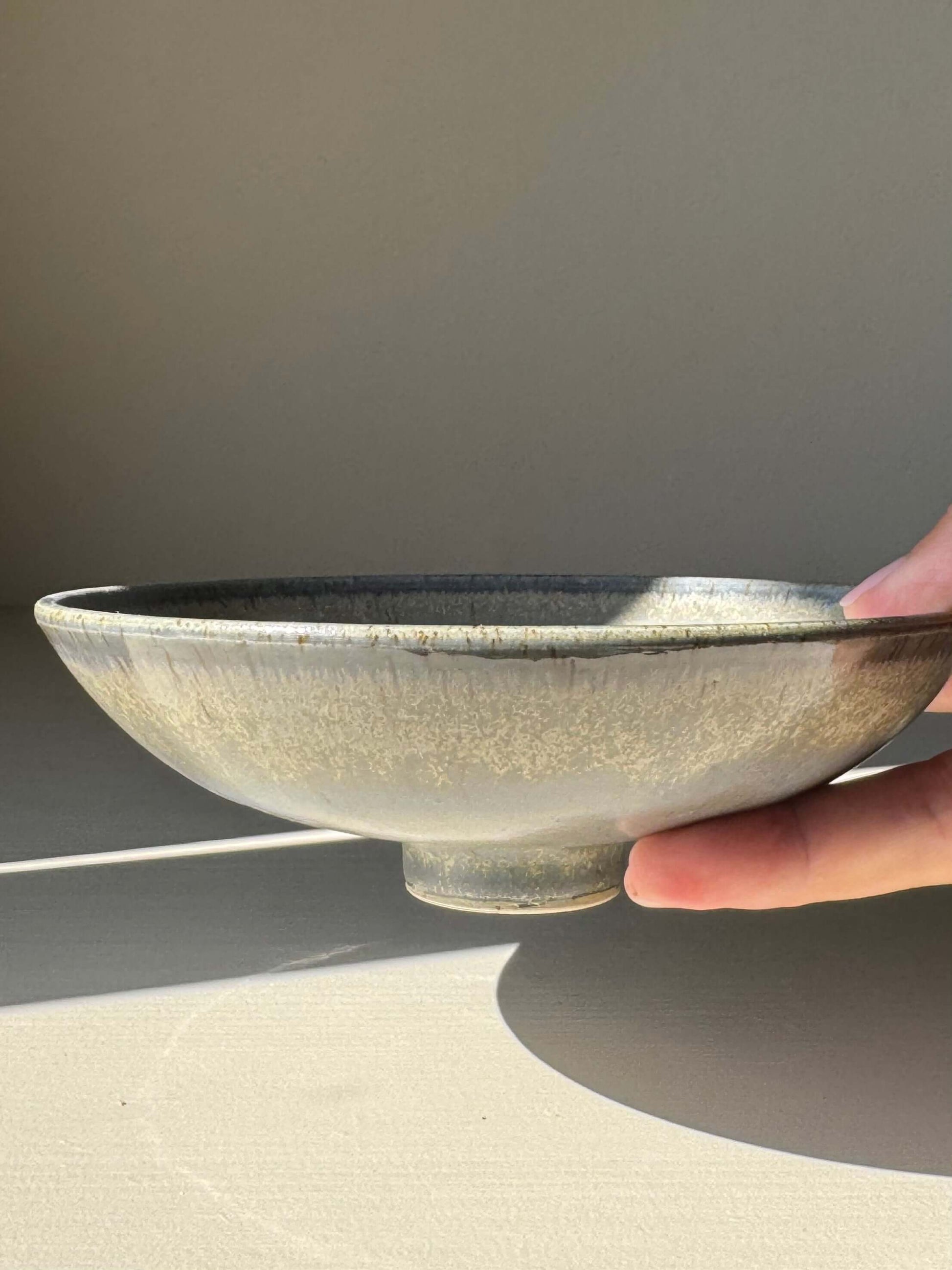 Trinket Dish - Satin Blue, handmade ceramic with satin finish, displayed at an angle with natural light highlighting its elegant design.