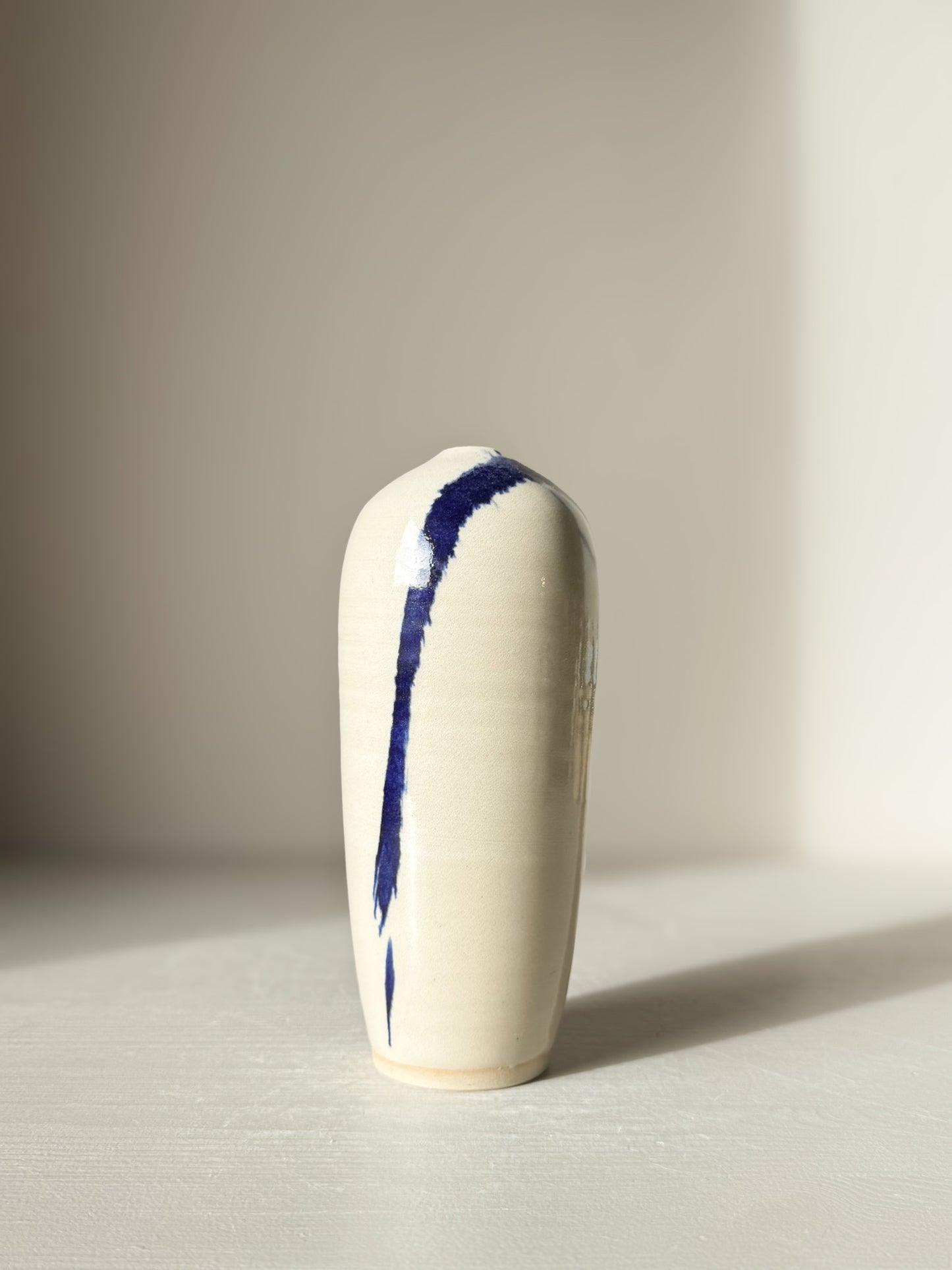 Ceramic Vase - Gosu #07 with hand-splashed cobalt blue accents and glossy clear glaze on a minimalist design.