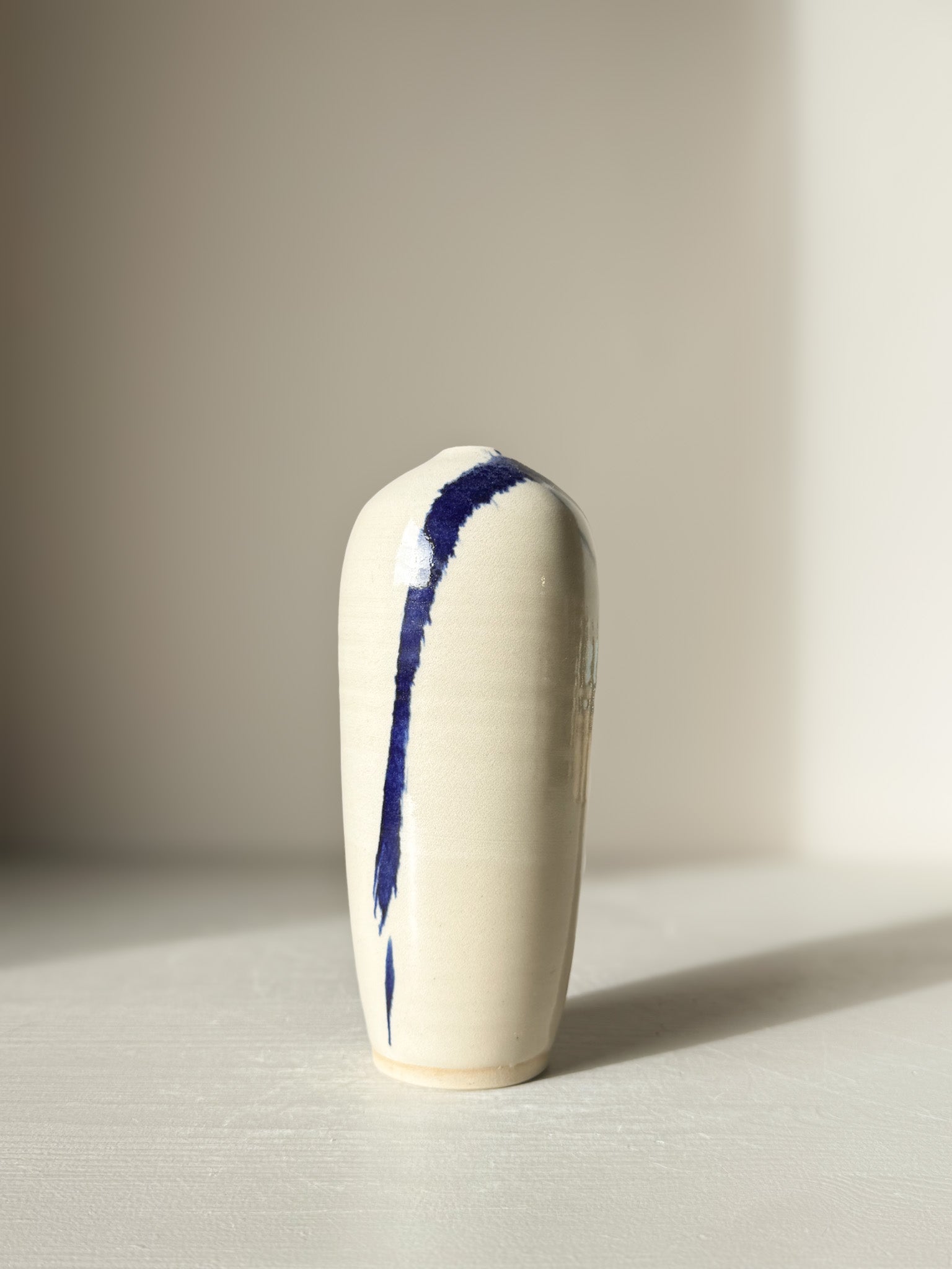 Ceramic Vase - Gosu #07 with hand-splashed cobalt blue accents and glossy clear glaze on a minimalist design.