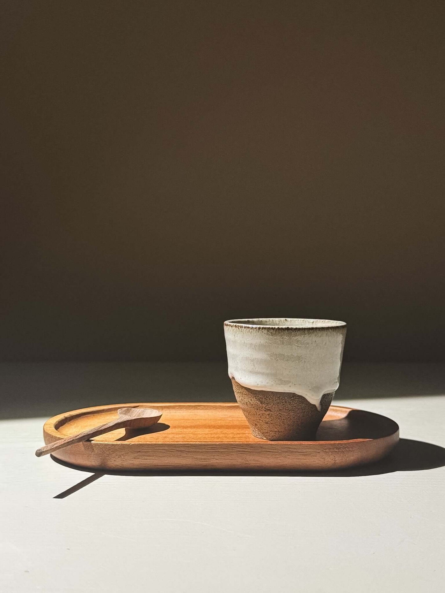 Espresso Cup - Yuki Ash on a wooden tray with a spoon, featuring an ash-grey and white glaze.