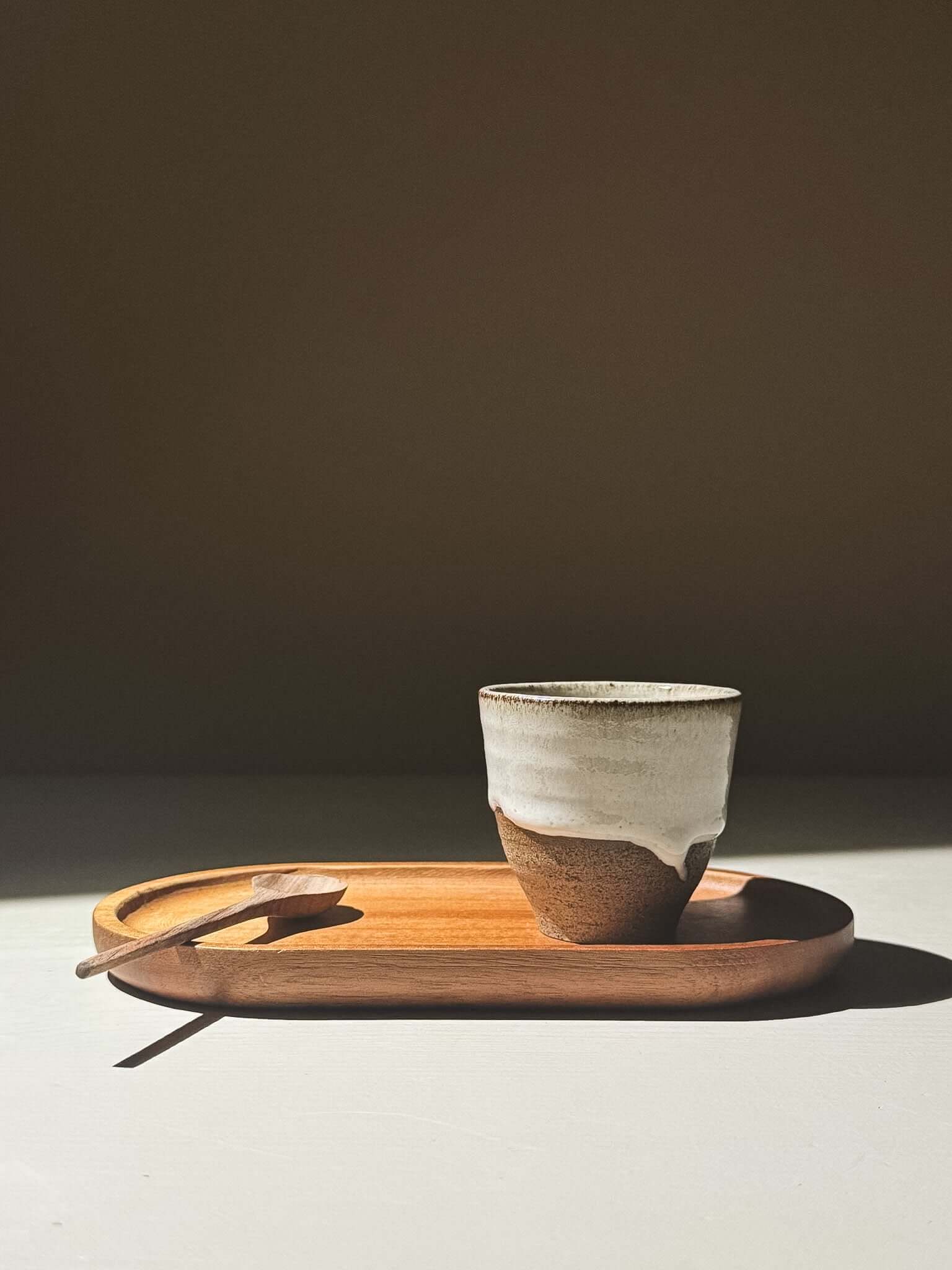 Espresso Cup - Yuki Ash on a wooden tray with a spoon, featuring an ash-grey and white glaze.