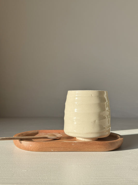 Yunomi Cups - Clear Glaze #01 showcasing a smooth, rounded form on a wooden tray, highlighting its natural texture and warmth.