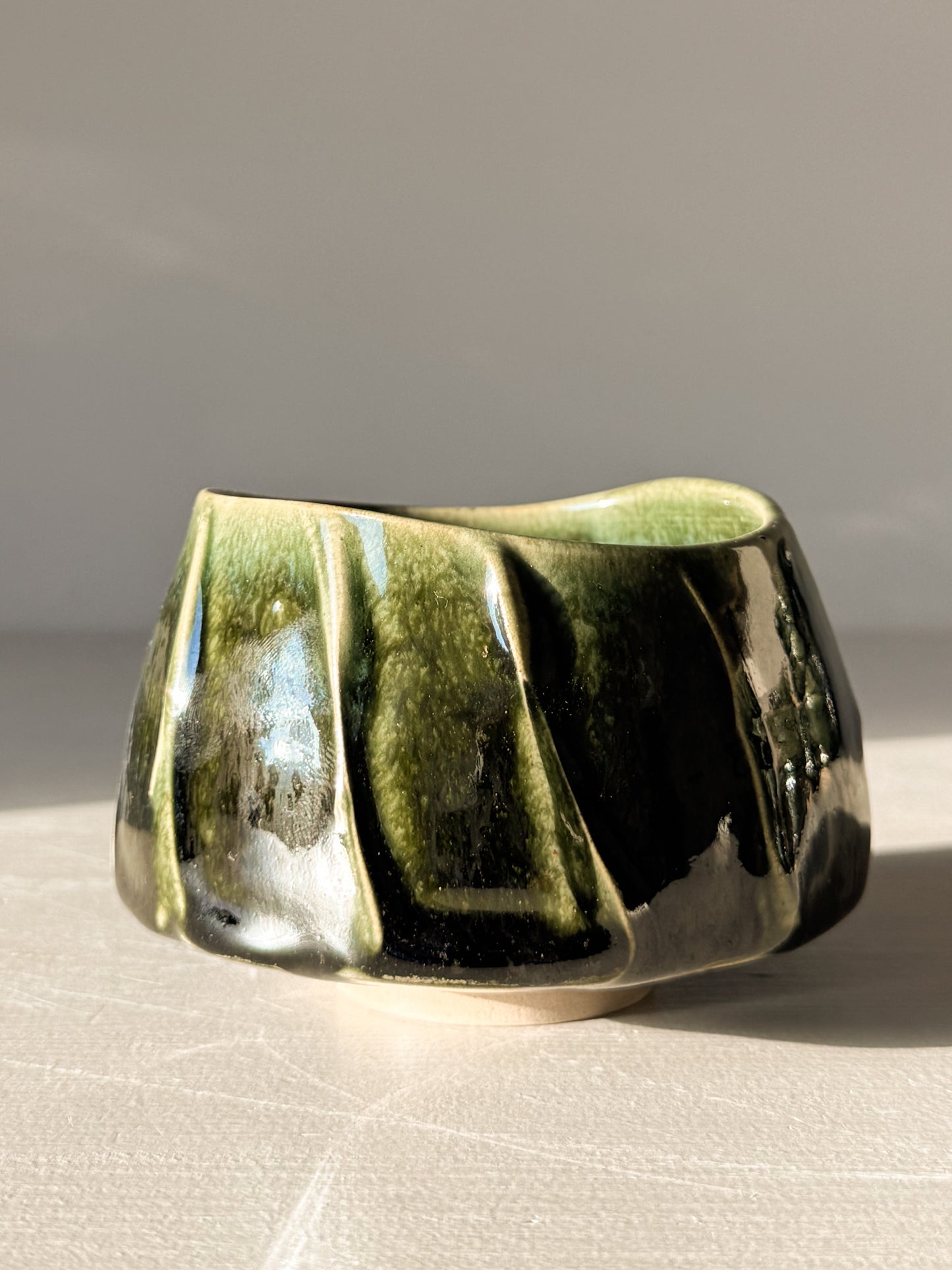 Handmade Yunomi Cup - Hinoki #07 with deep green glaze and slip decoration, showcasing unique texture and artisanal craftsmanship.