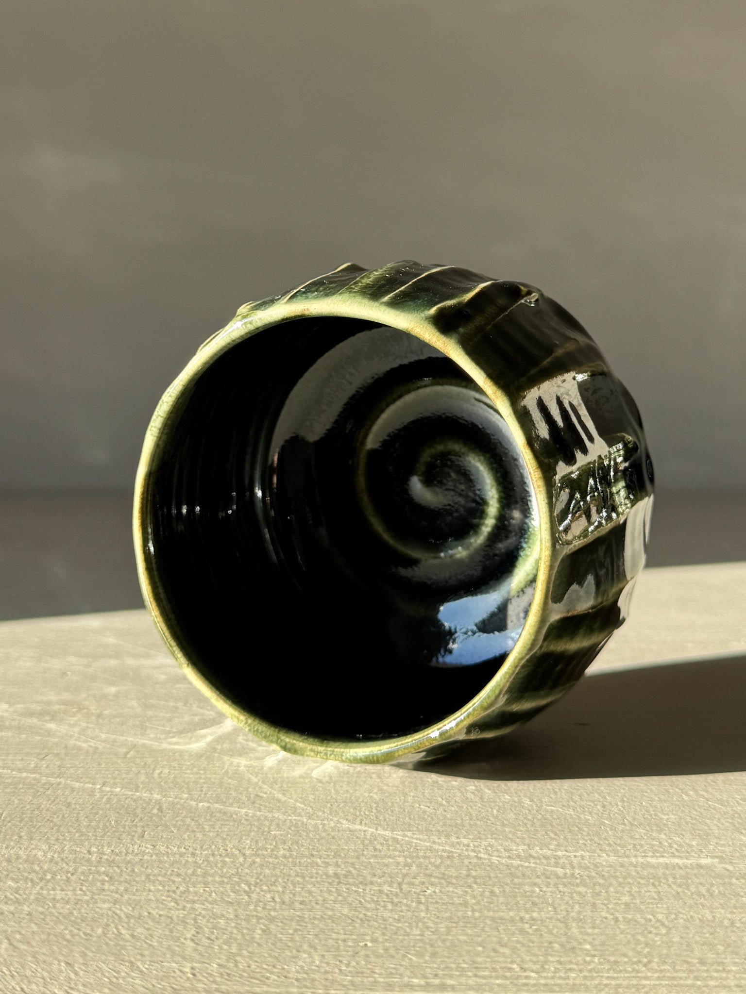 Yunomi Cup - Hinoki #11 with hand-applied slip decoration and deep green glaze highlighting its textured surface.