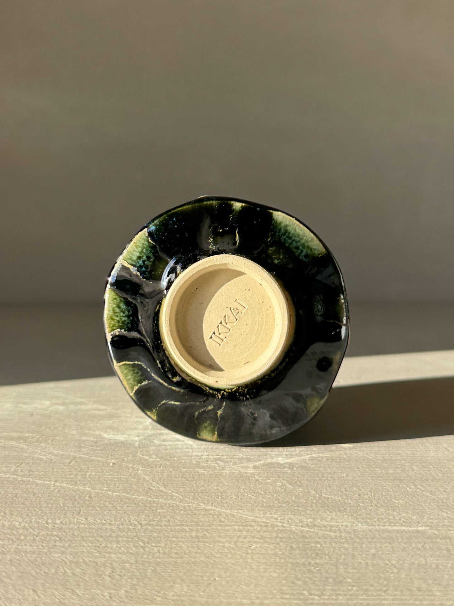 Bottom view of Yunomi Cup - Hinoki #18 showcasing deep green glaze and texture details.