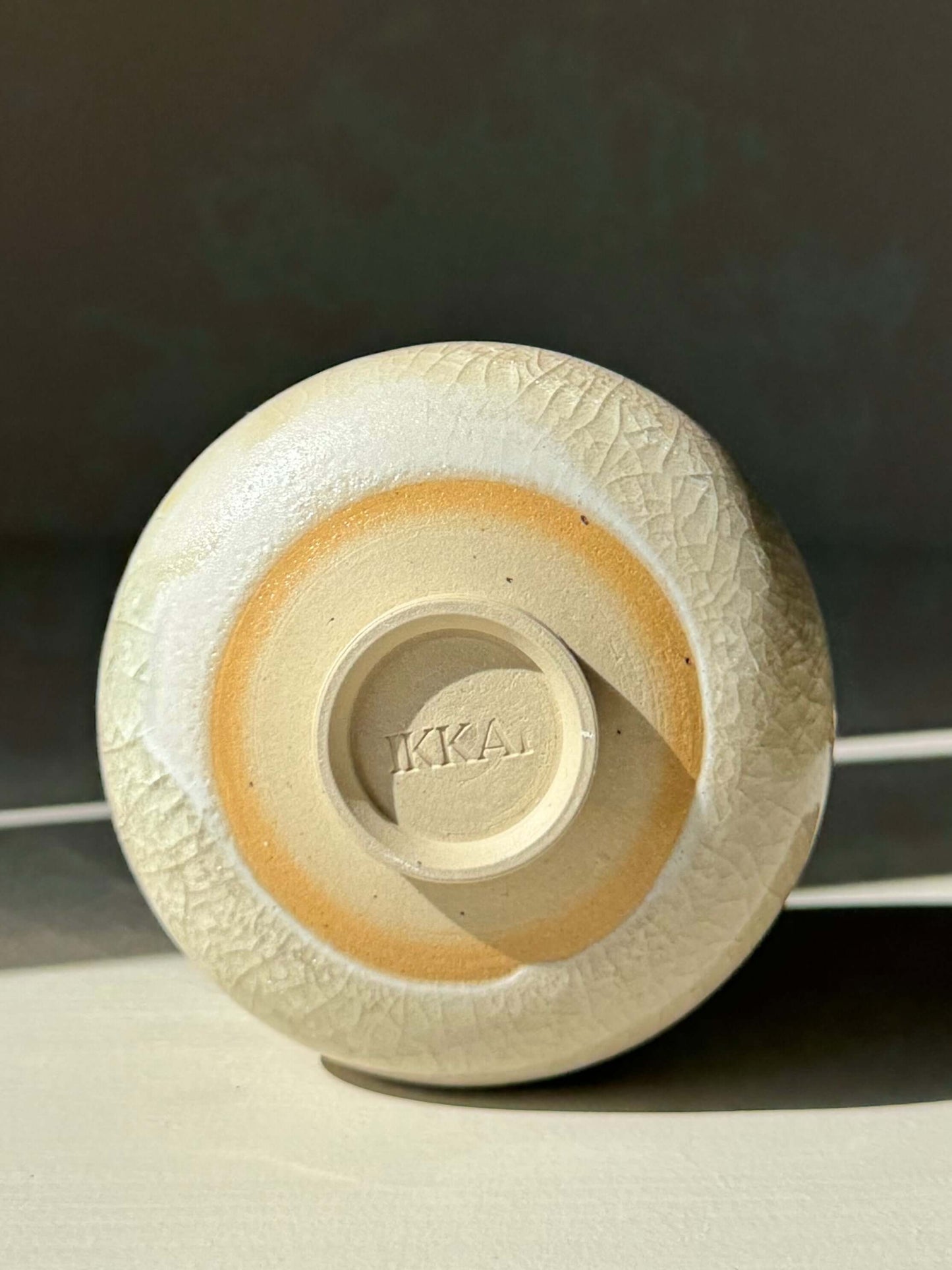 Bottom view of Yunomi Cup - Kannyū Series #11, featuring handmade ceramic with transparent crackle glaze pattern.
