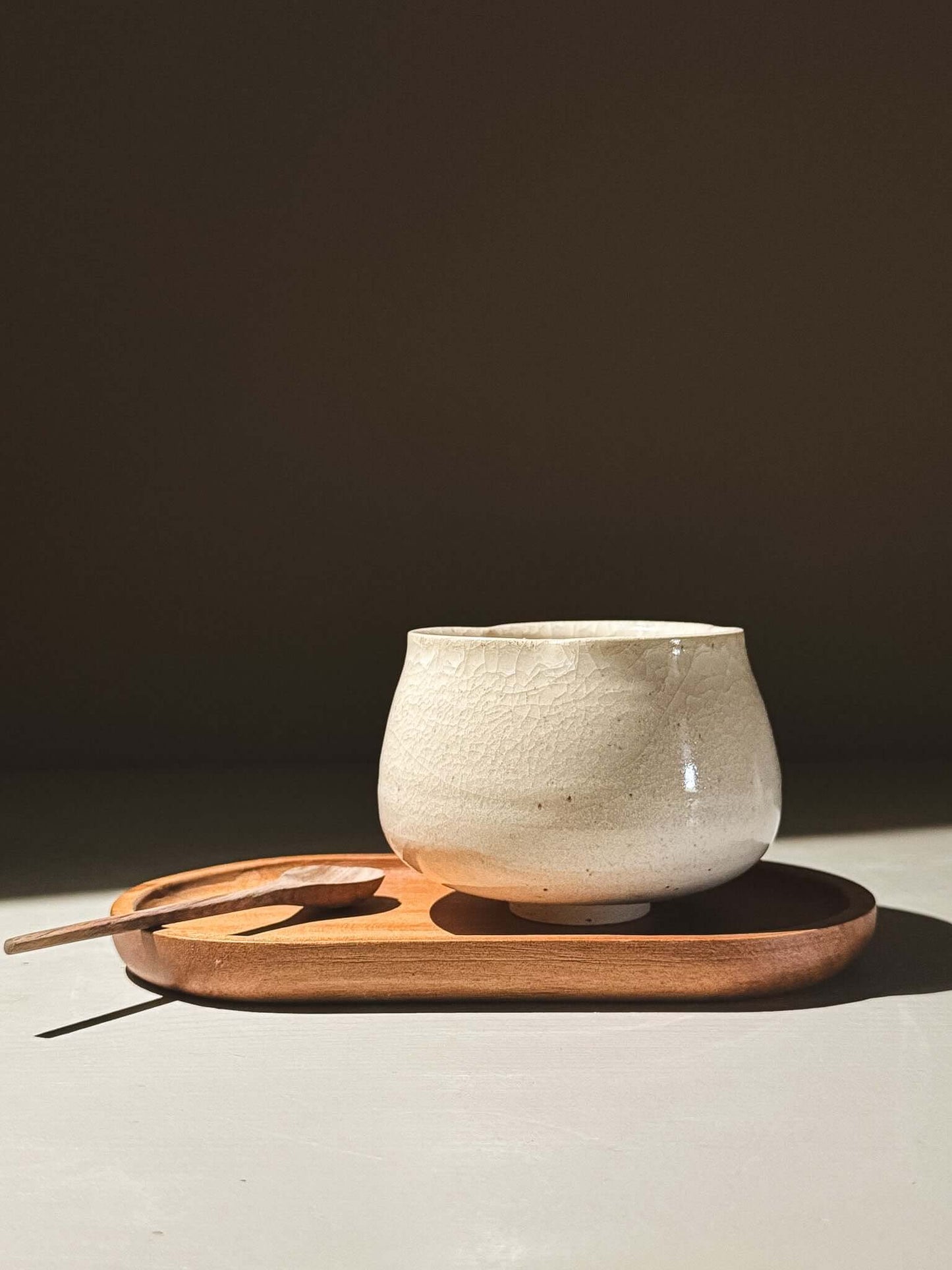 Yunomi Cup - Kannyū Series  #12 on a wooden tray with a spoon, showcasing its elegant design and delicate glaze.