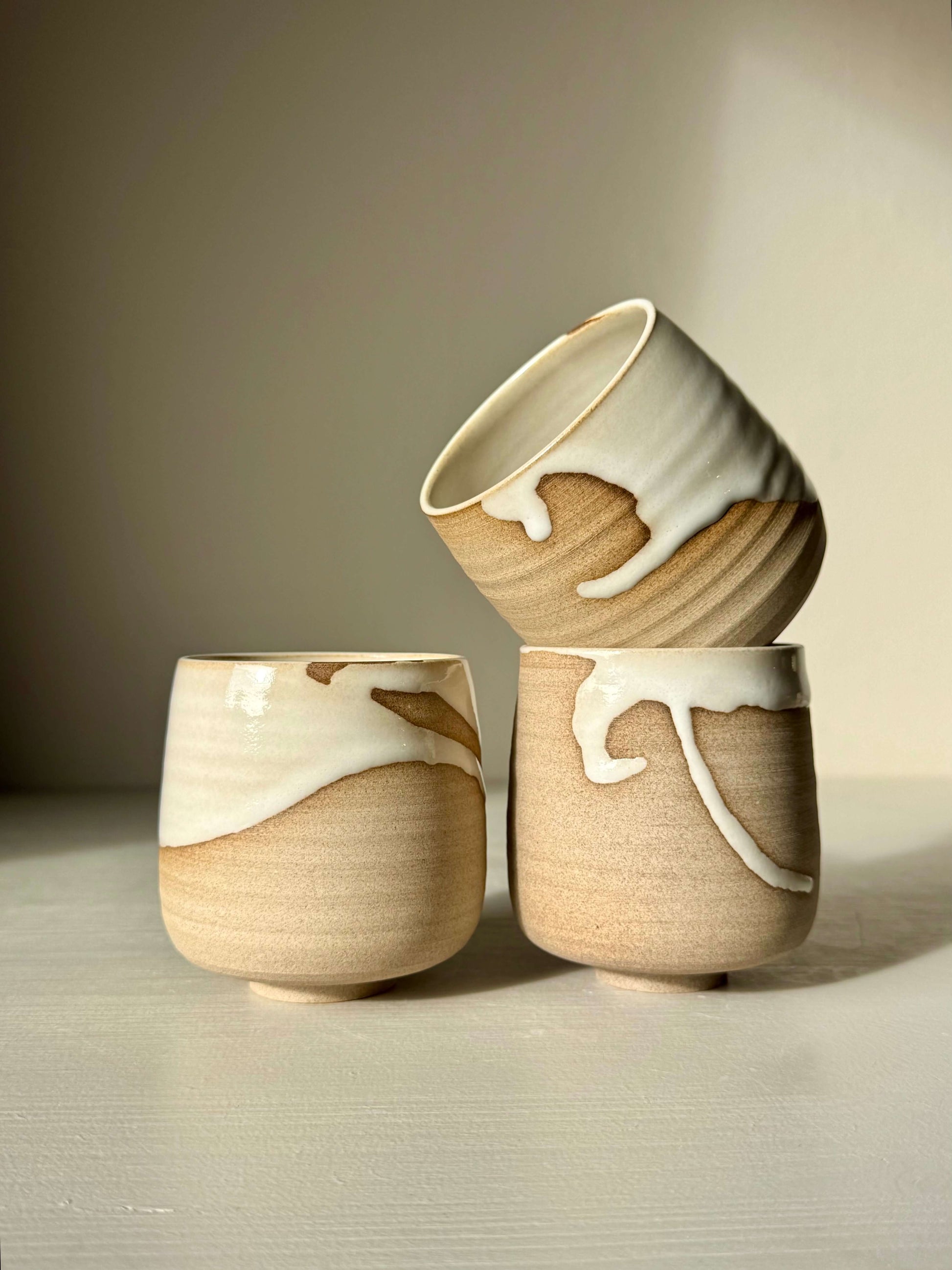 Handmade ceramic Yunomi Cups - Yuki with white glaze and toffee clay, showcasing unique drips and rustic charm.