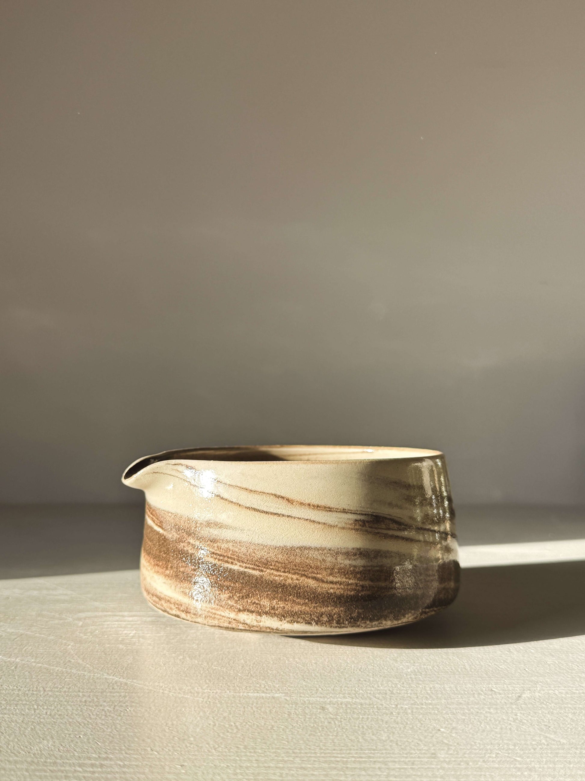Hand-thrown Matcha Bowl Spout - Marbled #01 with swirling black and white stoneware clay and clear glaze on display.